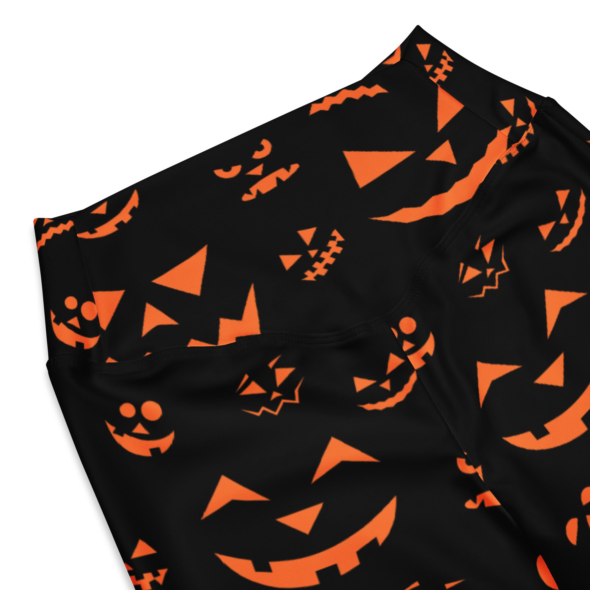 Women’s black high waist flare leggings with vibrant orange jack-o-lantern pumpkin face pattern for Halloween