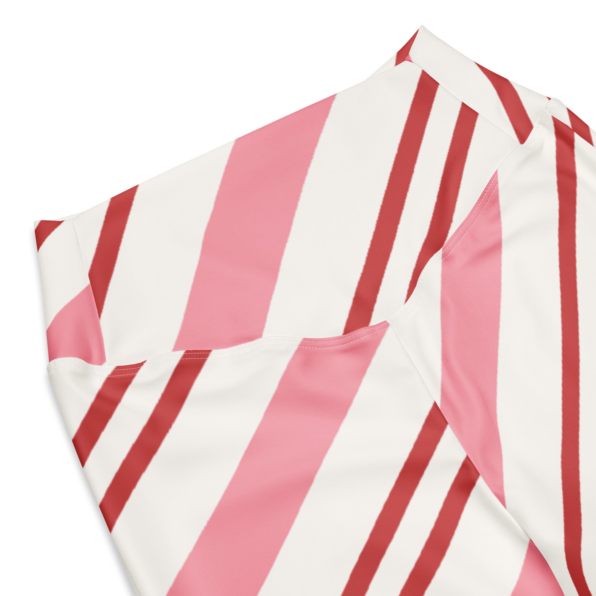 A women’s short-sleeved shirt with bold pink and red diagonal stripes on smooth glossy fabric for stylish wear