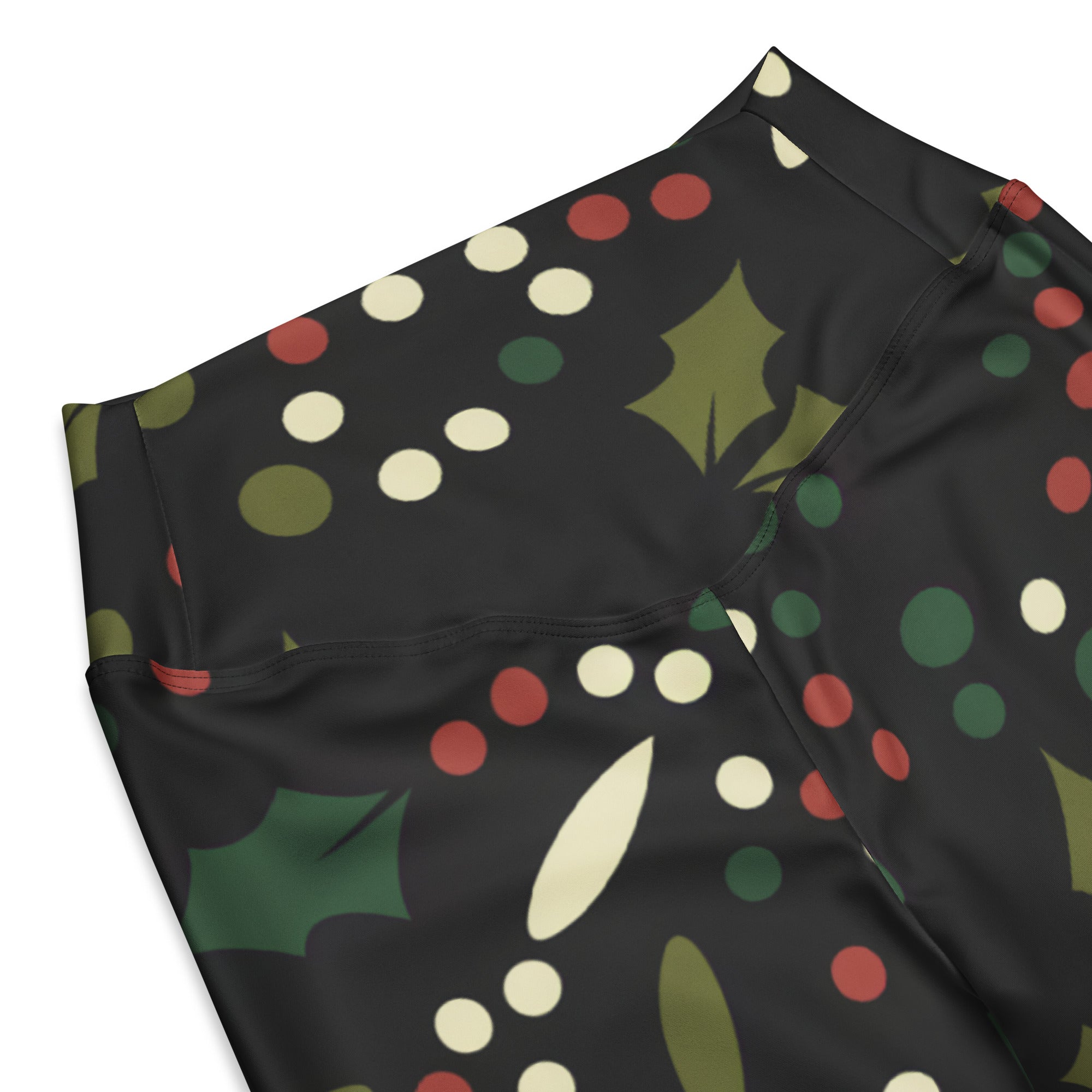 Women’s black high-waisted flare leggings with festive holly print green leaves red and white polka dots and olive accents