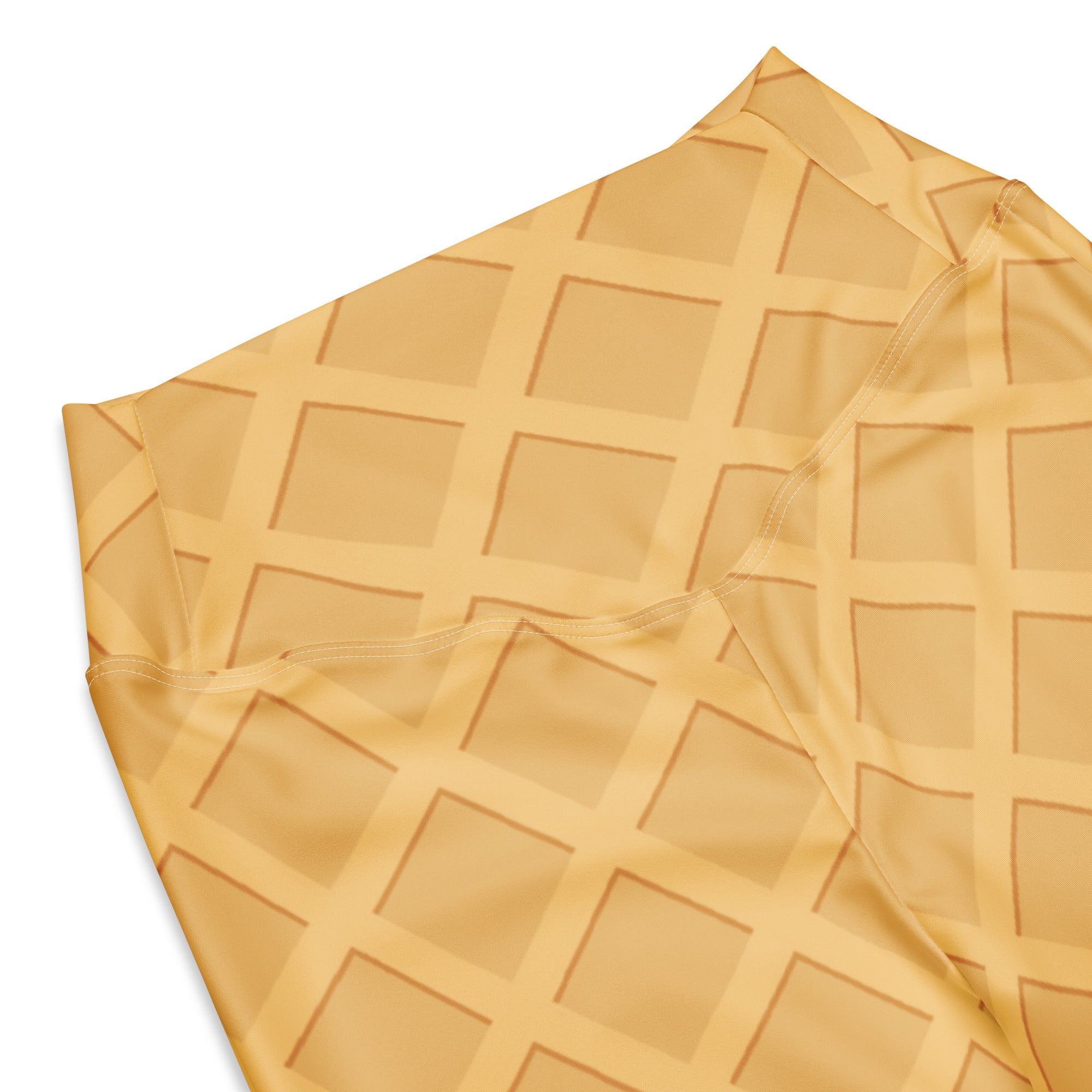 Soft golden-yellow waffle texture fabric of women’s waffle cone high waist flare legging pants closeup
