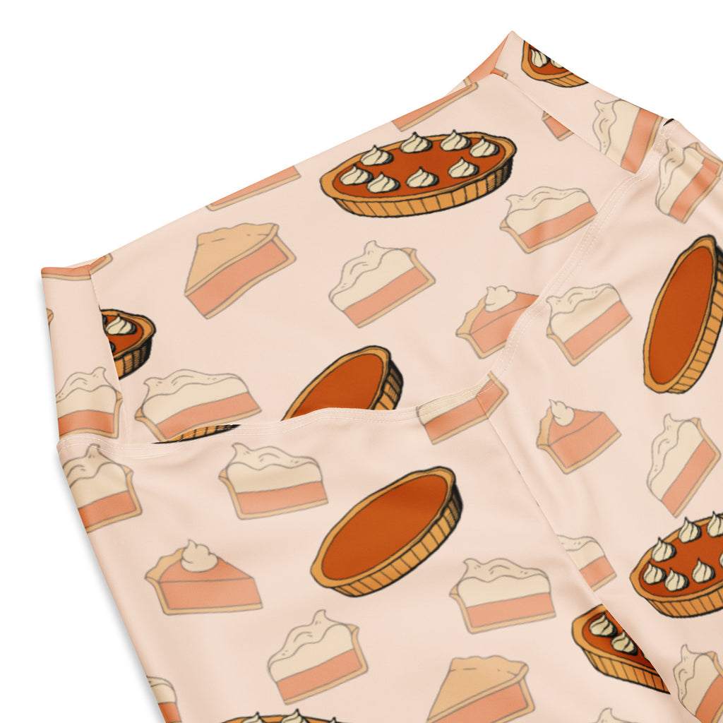 Women’s pink high waist flare legging pants with repeating warm orange and cream pumpkin pie pattern for thanksgiving