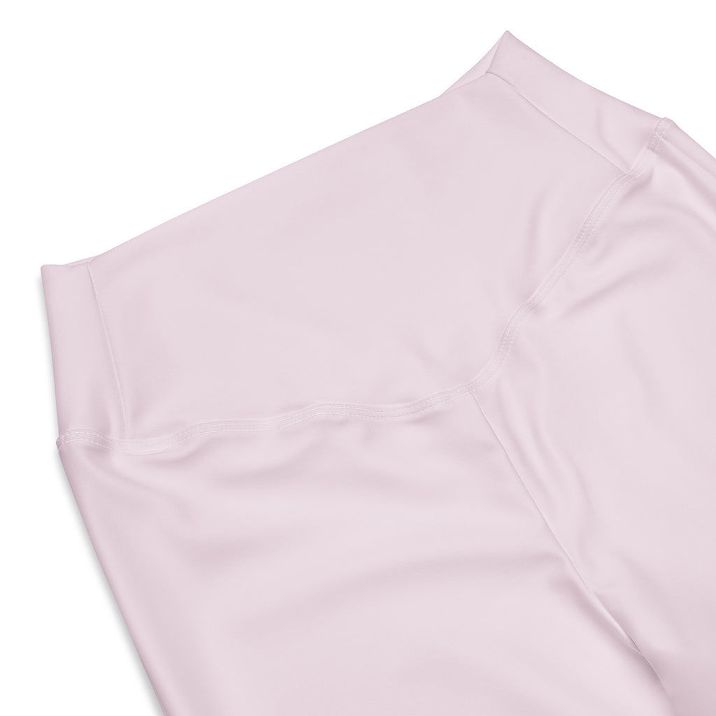 A soft blush pink high waist flare legging pant made of smooth stretchy fabric with clean stitching for women