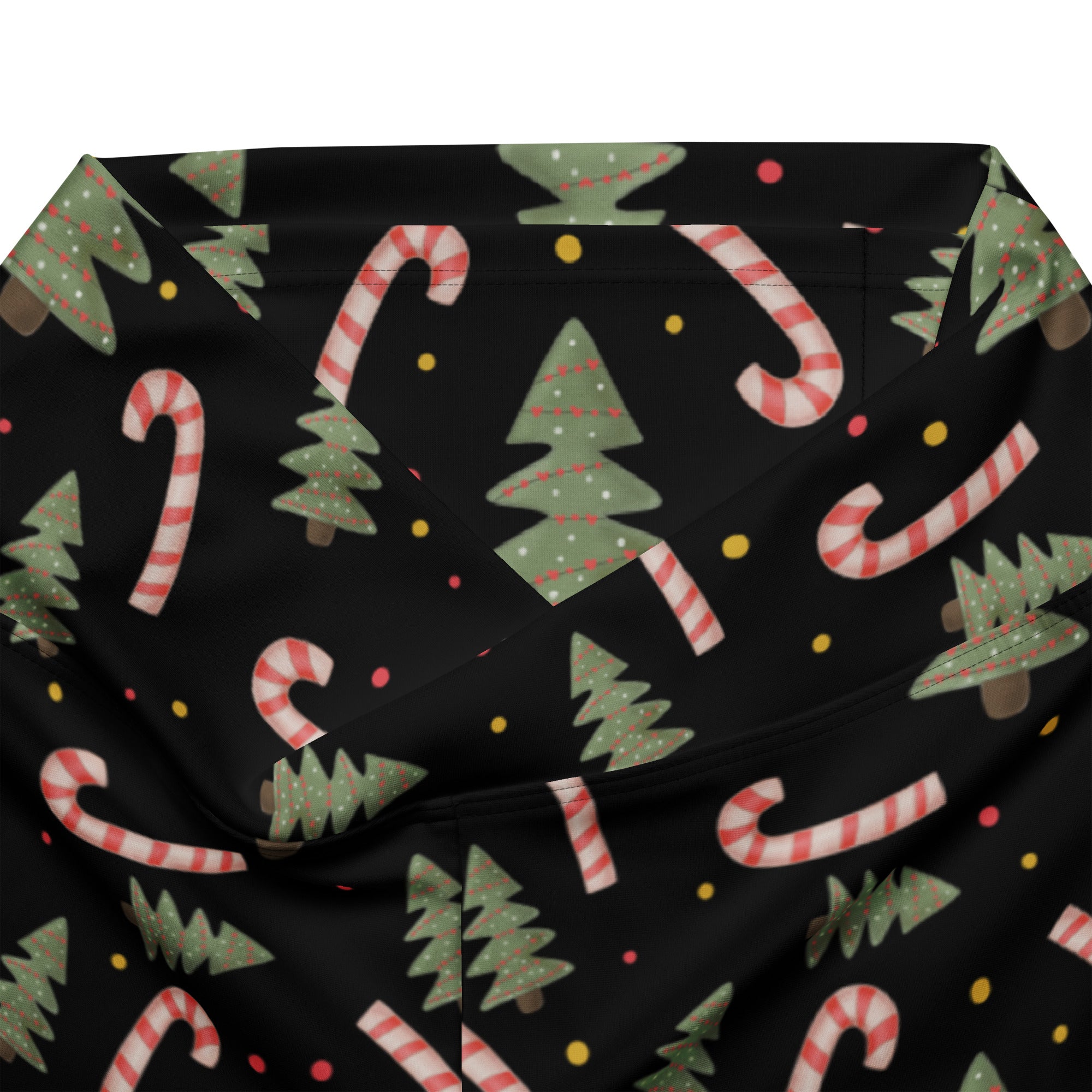 Women’s black high waist flare legging pants with festive green christmas trees and red white candy cane pattern