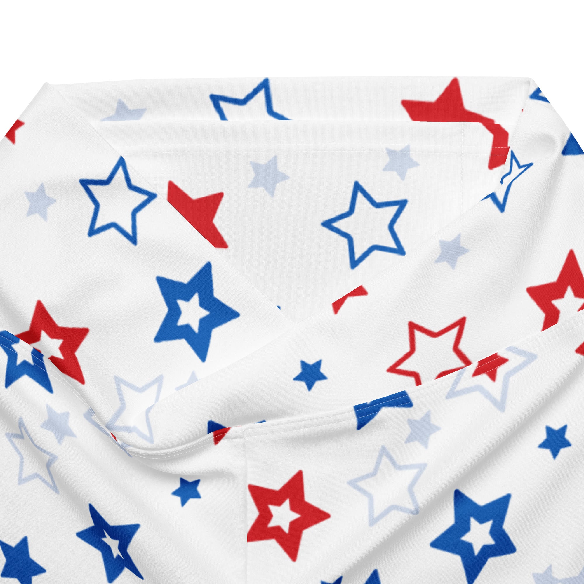 White fabric women’s high waist flare legging pants with playful red blue and light gray star pattern