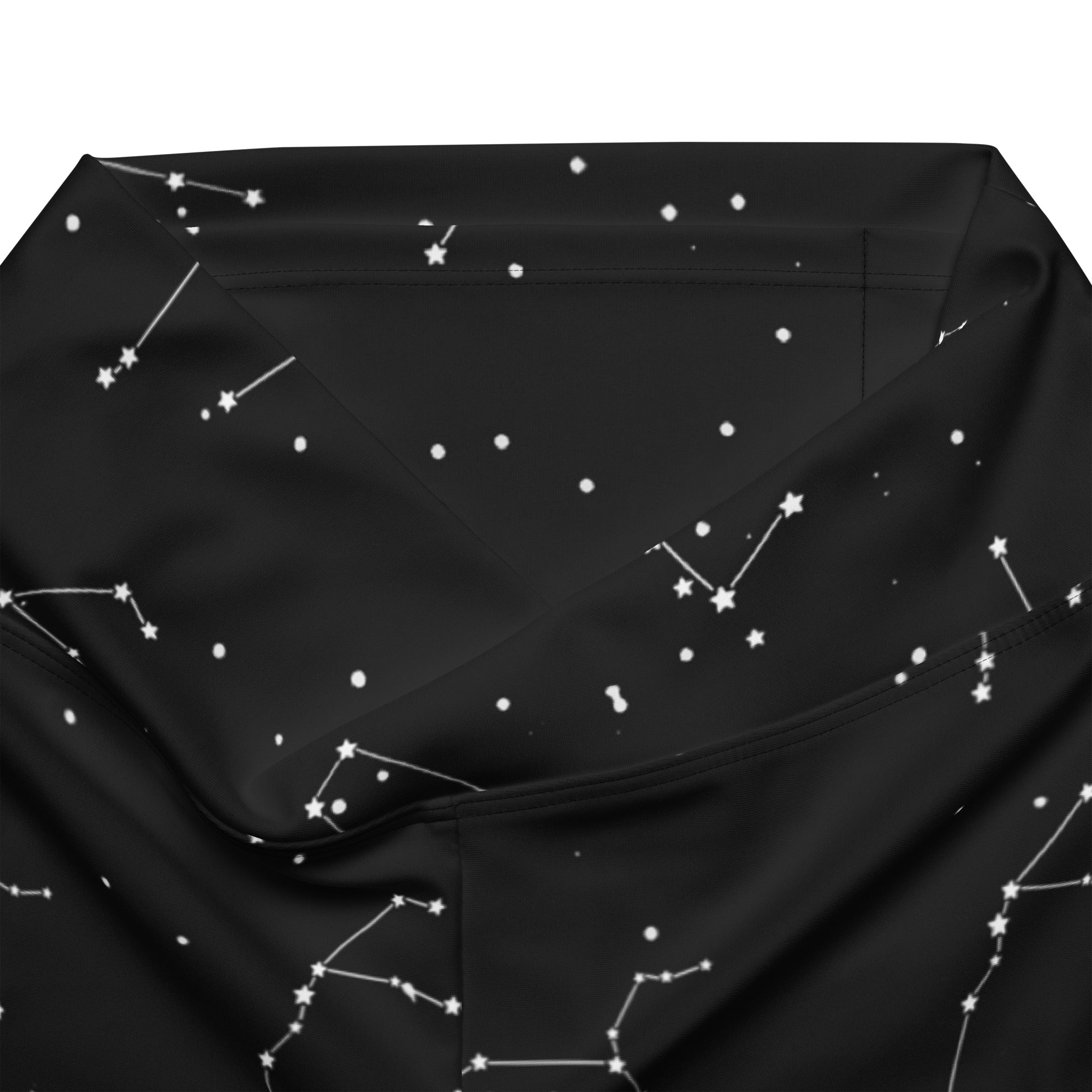 Women’s high waist flare legging pants in black fabric with white star and constellation pattern design