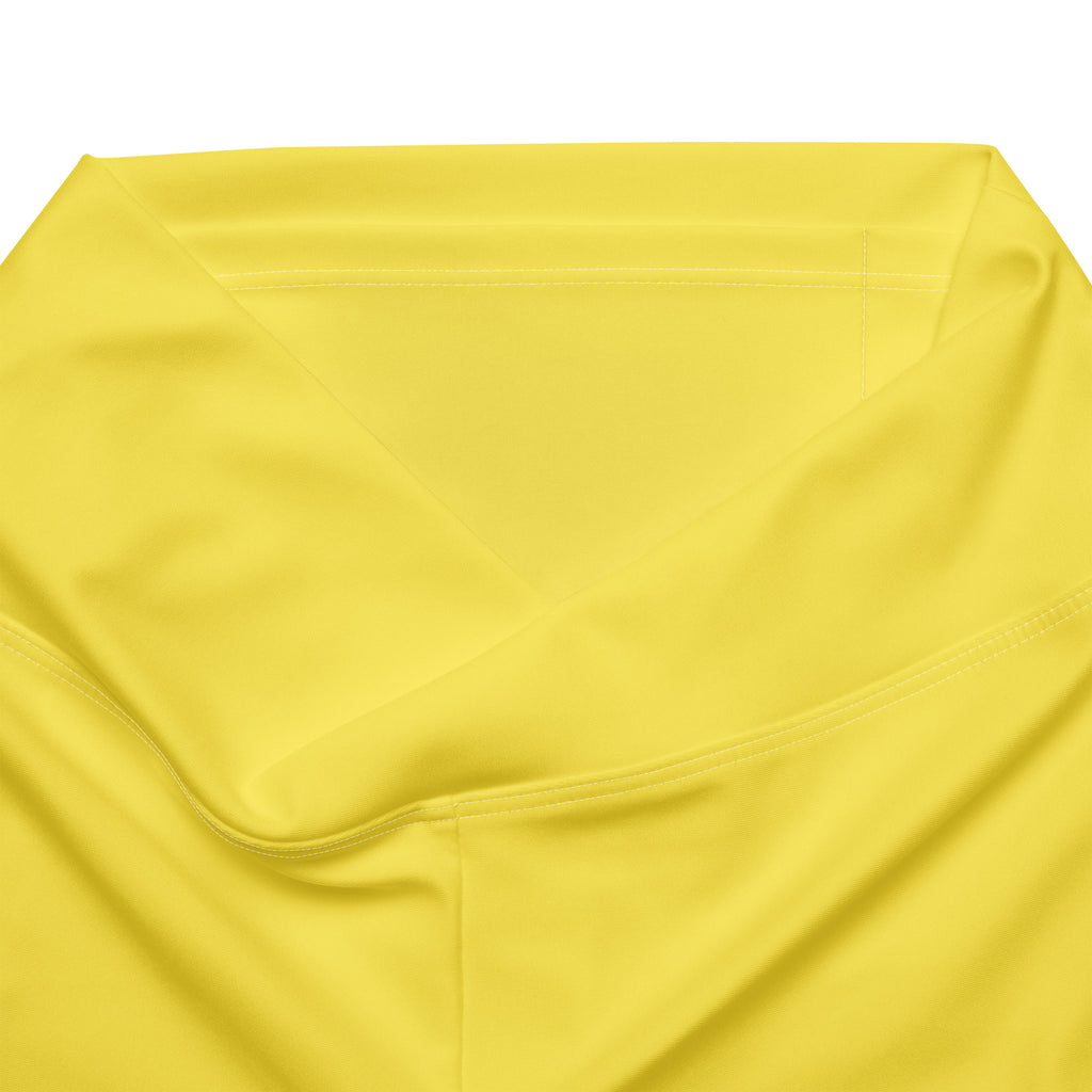 Women’s yellow high waist flare legging pants made of bright satin-like fabric with smooth glossy texture and stitching details