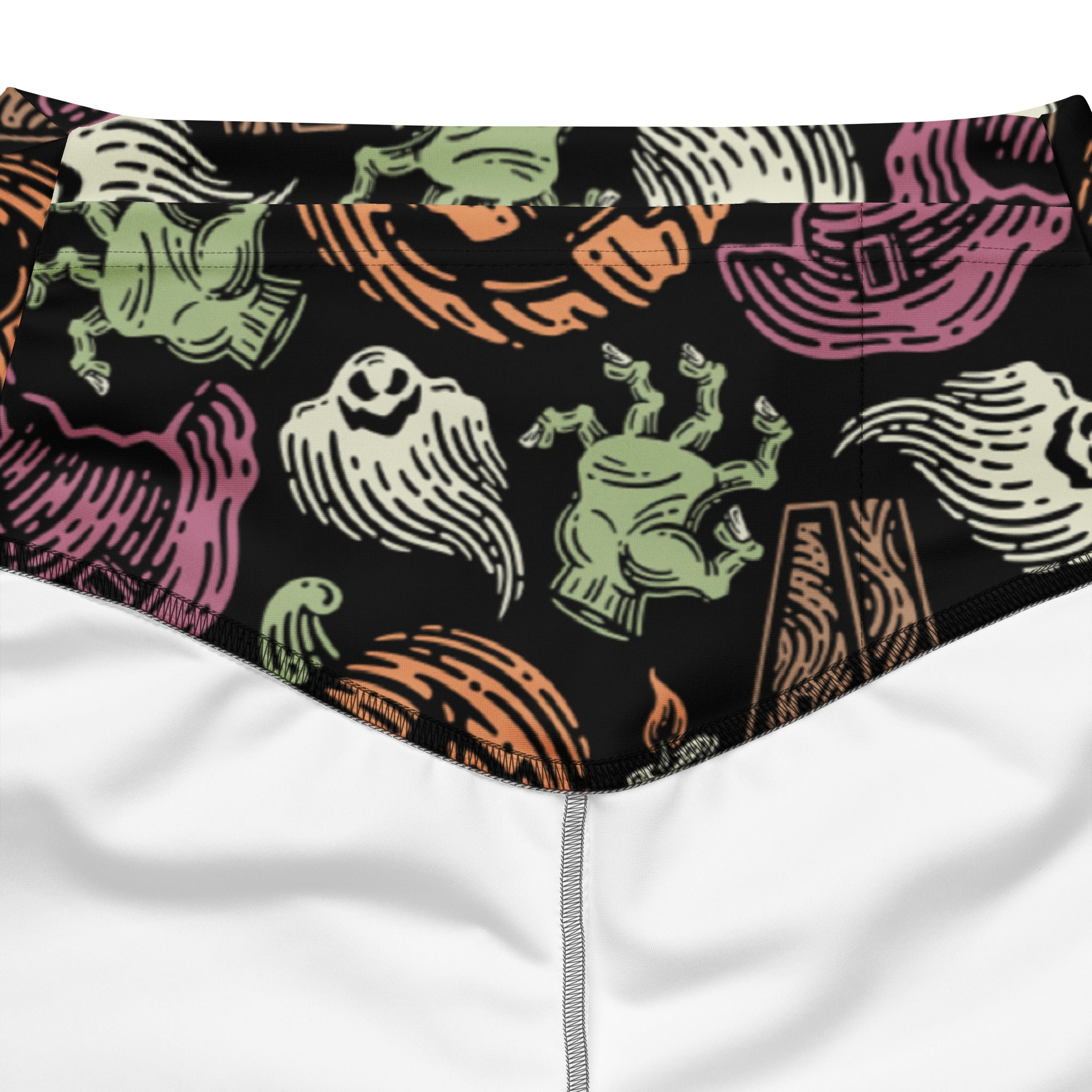 Black swim trunks with playful halloween pattern of green ghosts pink witch hats and orange pumpkins in line art design