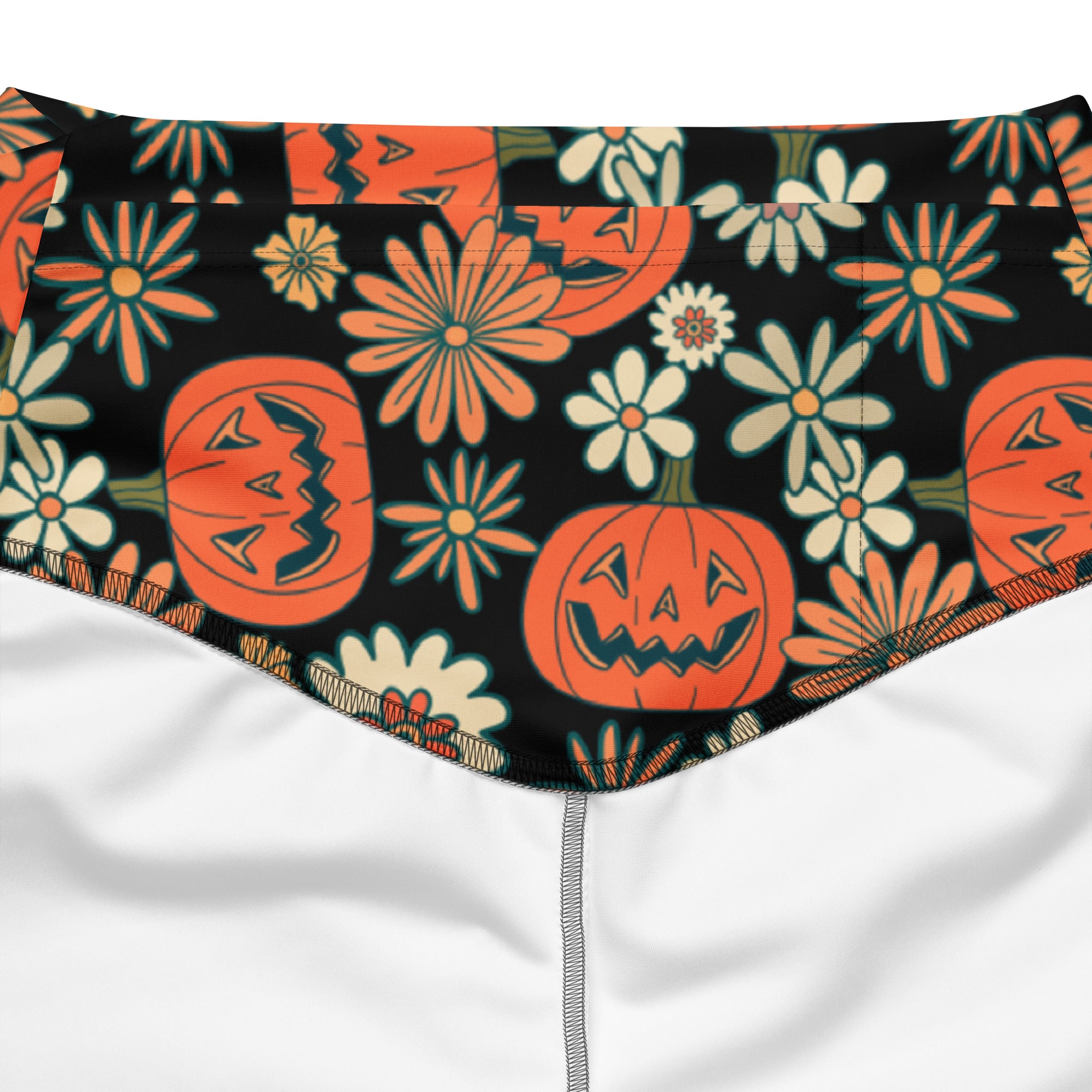 Women’s retro halloween high waist flare legging pants in black with orange jack o lantern and cream teal floral pattern
