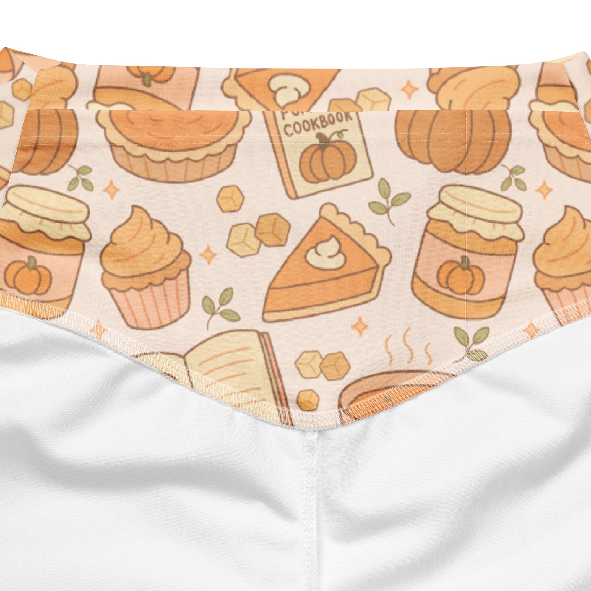 A cream-colored soft fabric bandana with autumn-themed pumpkin pie pattern in orange and beige illustrations