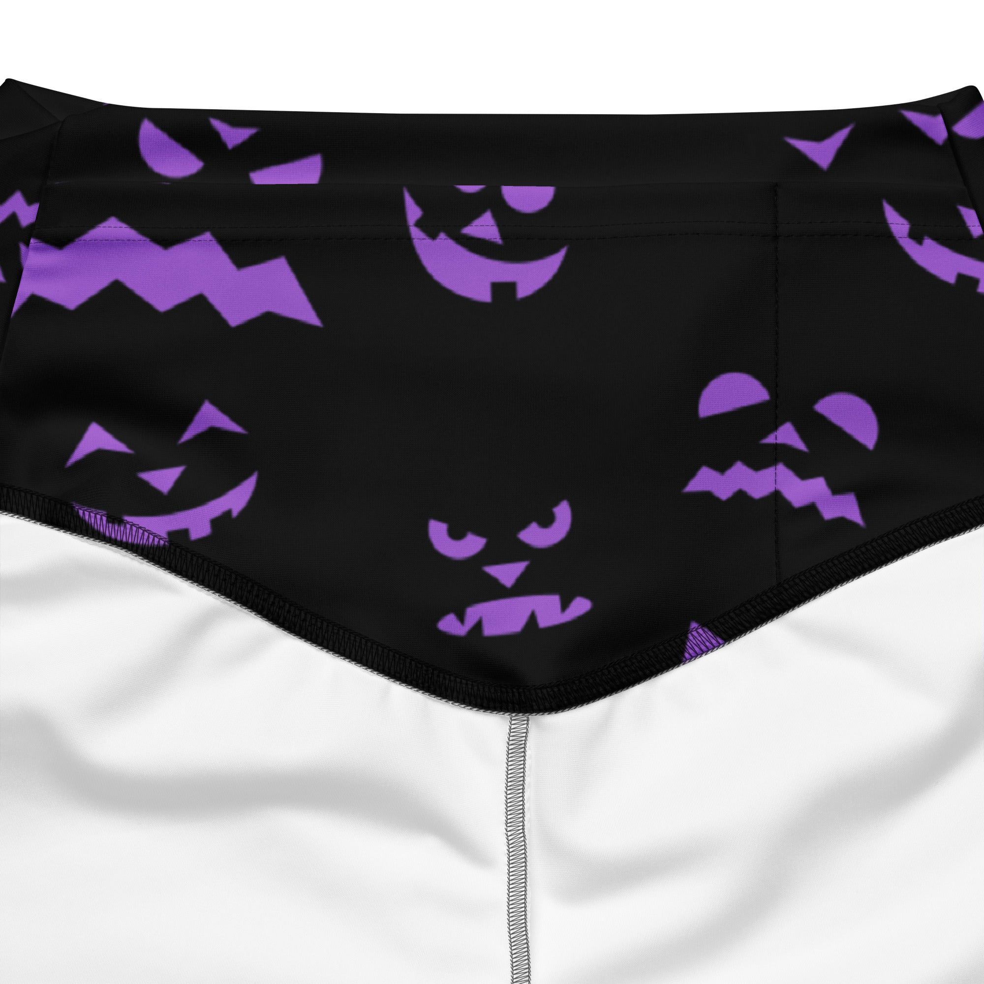 Black swim trunks with a playful pattern of purple jack-o-lantern faces perfect for halloween swimwear