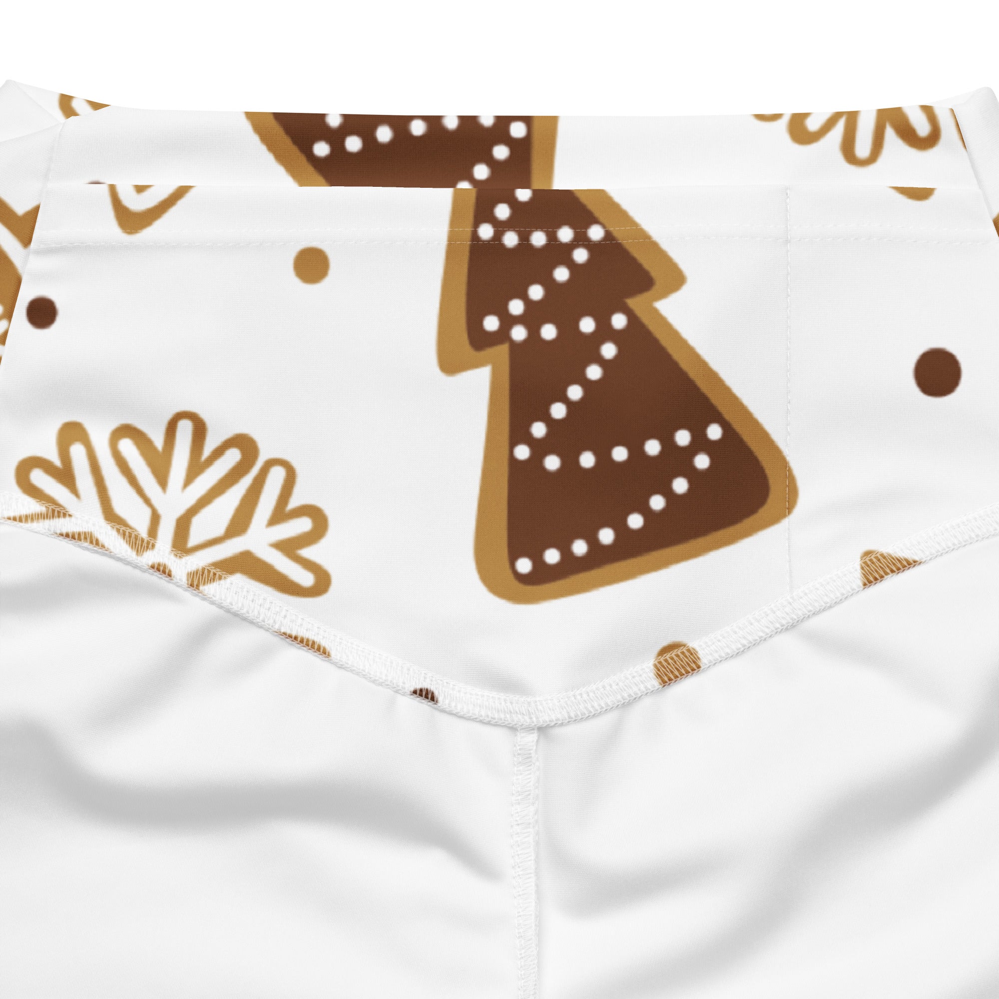White women’s high waist flare legging pants with festive gingerbread tree and snowflake pattern in brown and gold