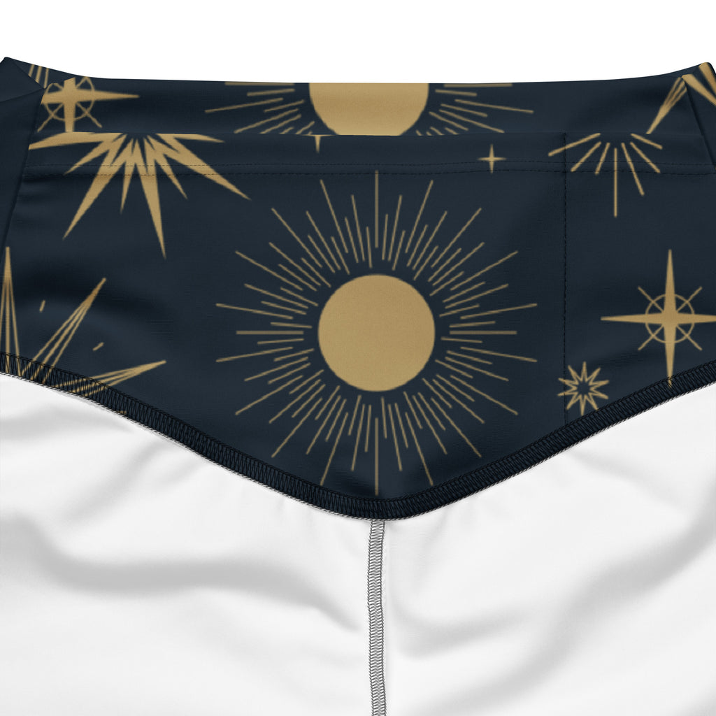 Dark blue women’s high waist flare legging pants with bold gold sunburst and star pattern celestial design