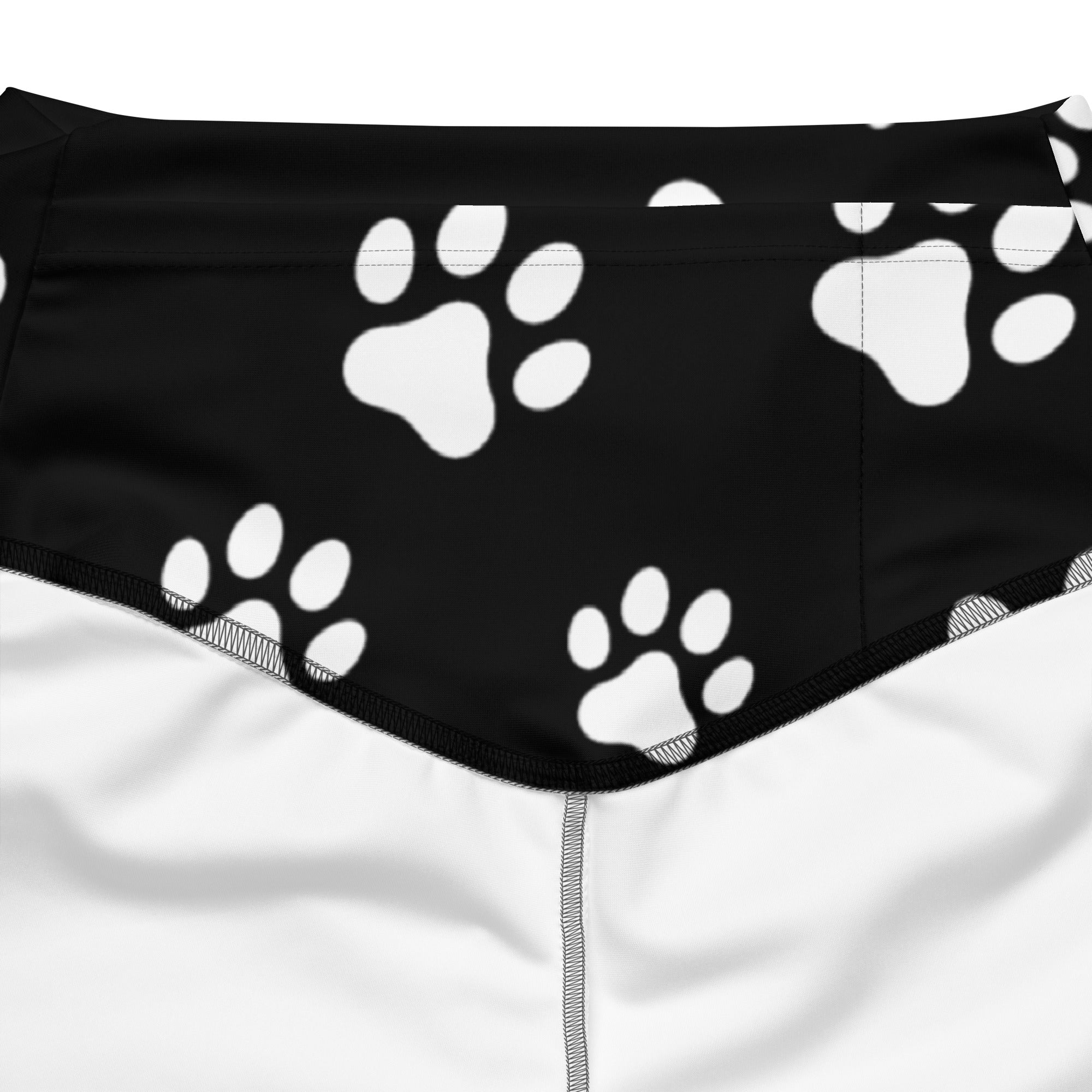 Women’s black high waist flare legging pants with bold white paw print pattern on soft stretchy fabric