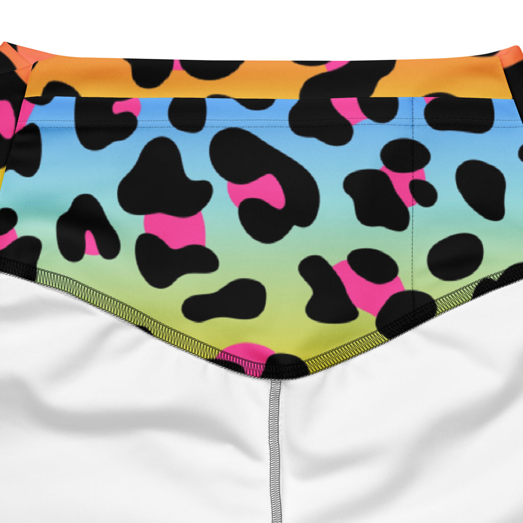 Women’s rainbow leopard high waist flare legging pants in vibrant neon leopard print with a blue green orange gradient background