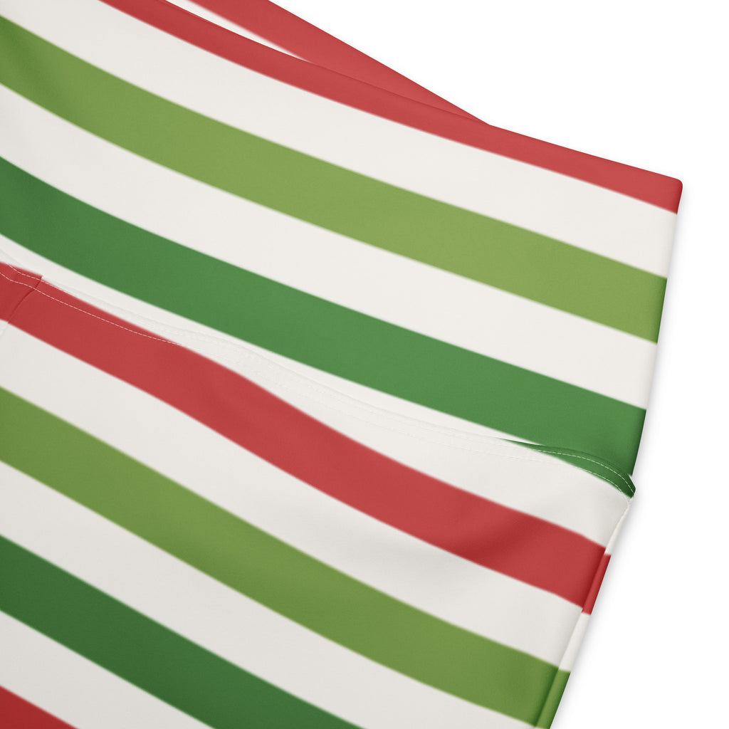 Women’s yellow high waist flare legging pants featuring bold diagonal stripes in red green and white fabric detail