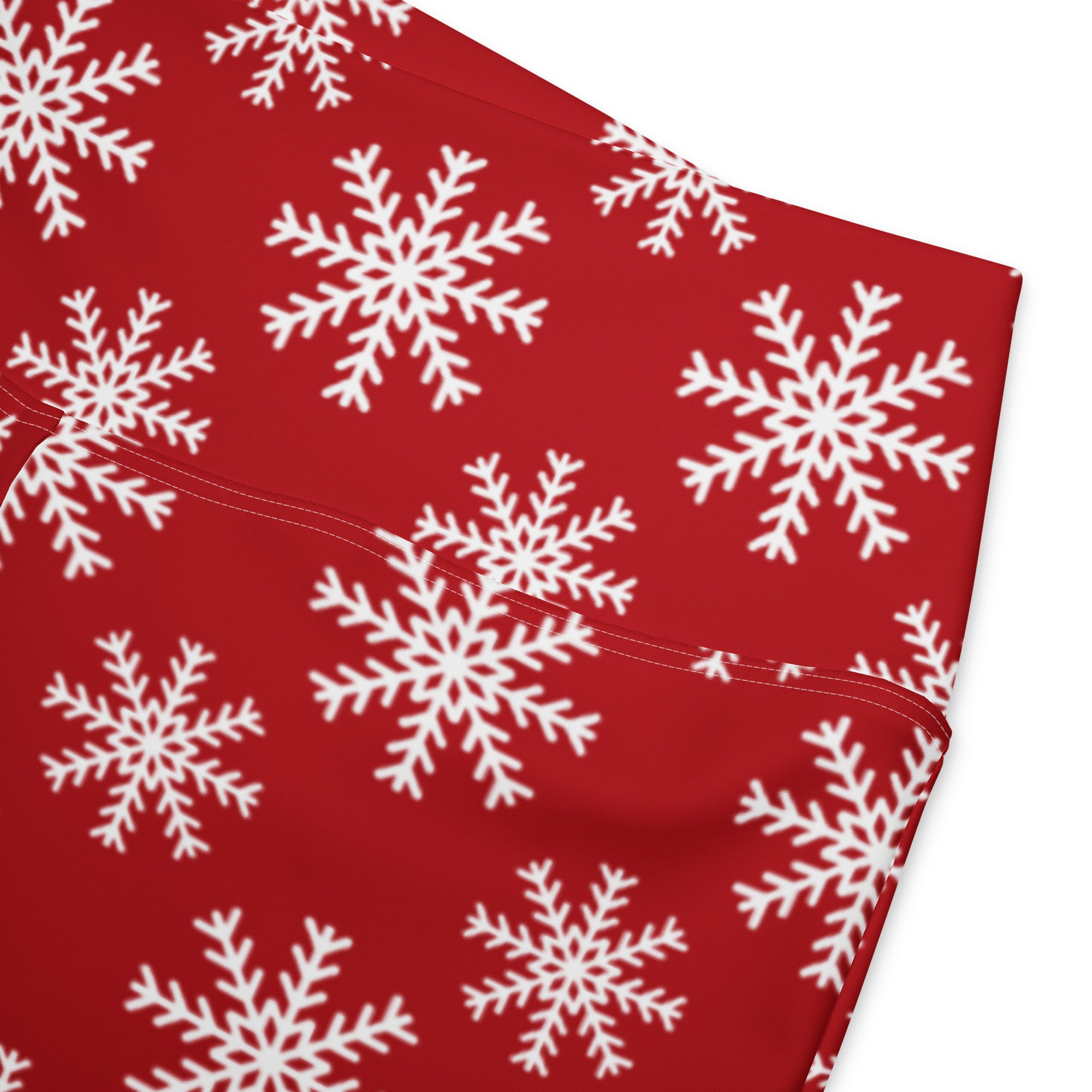 Women’s red high waist flare legging pants with white snowflake pattern on festive winter fabric