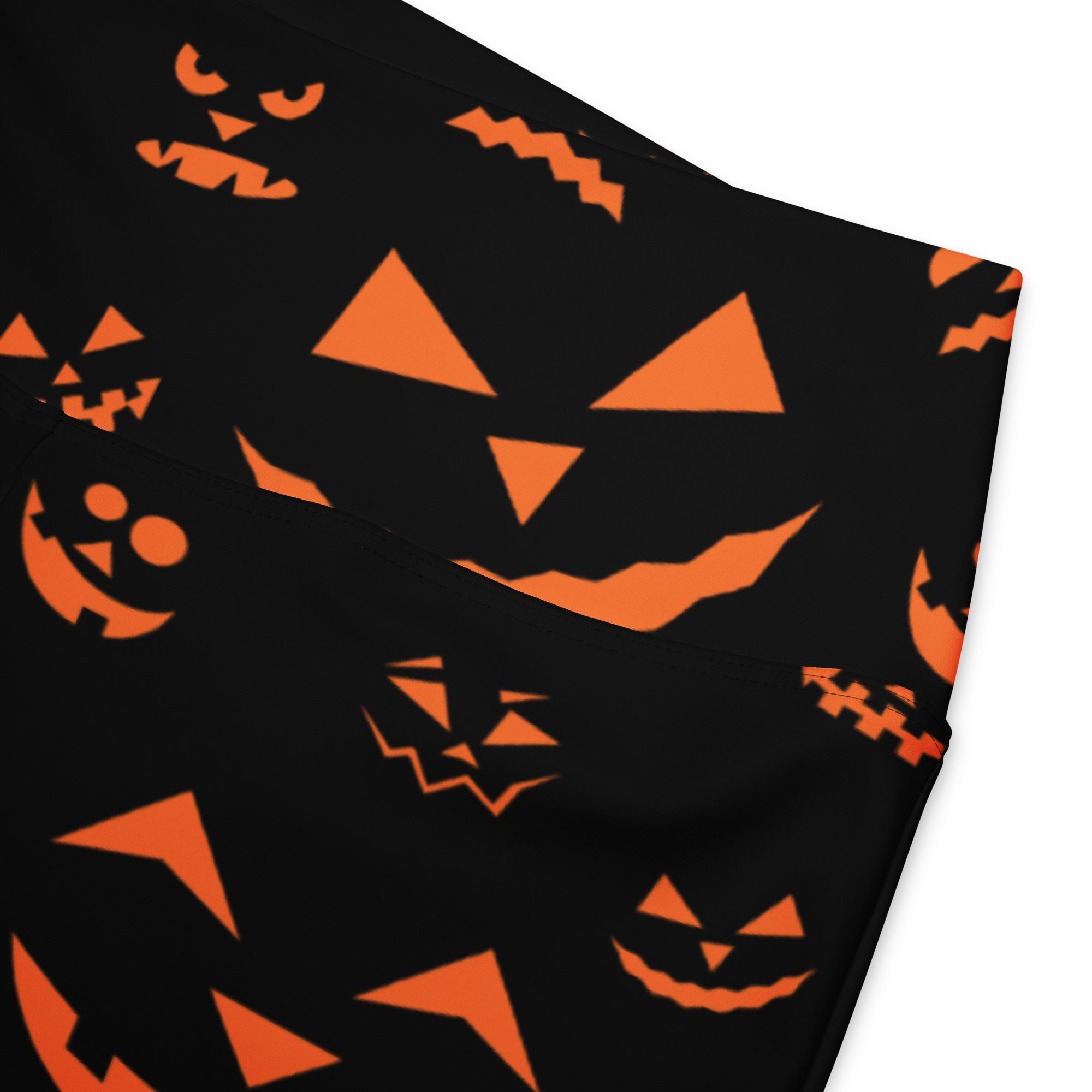 Women’s black high waist flare legging pants with orange jack o lantern face patterns for halloween