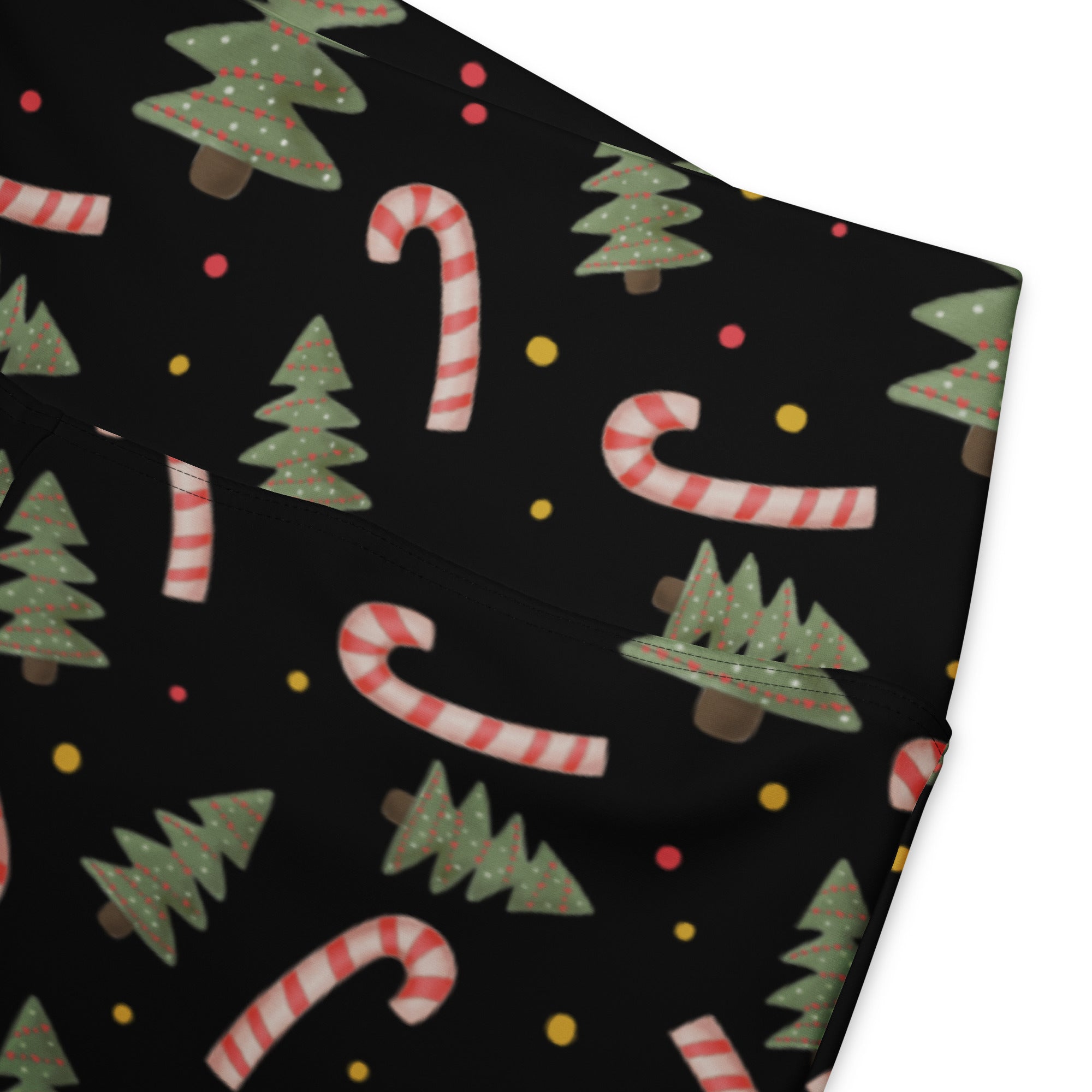 Black women’s high waist flare legging pants with festive green christmas trees and red white candy cane pattern