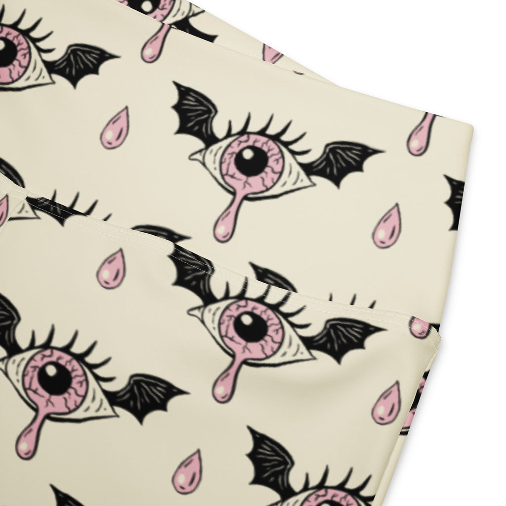 Cream-colored women’s gothic eyeball bat high waist flare leggings with pink bat-winged eyes pattern and black pupils