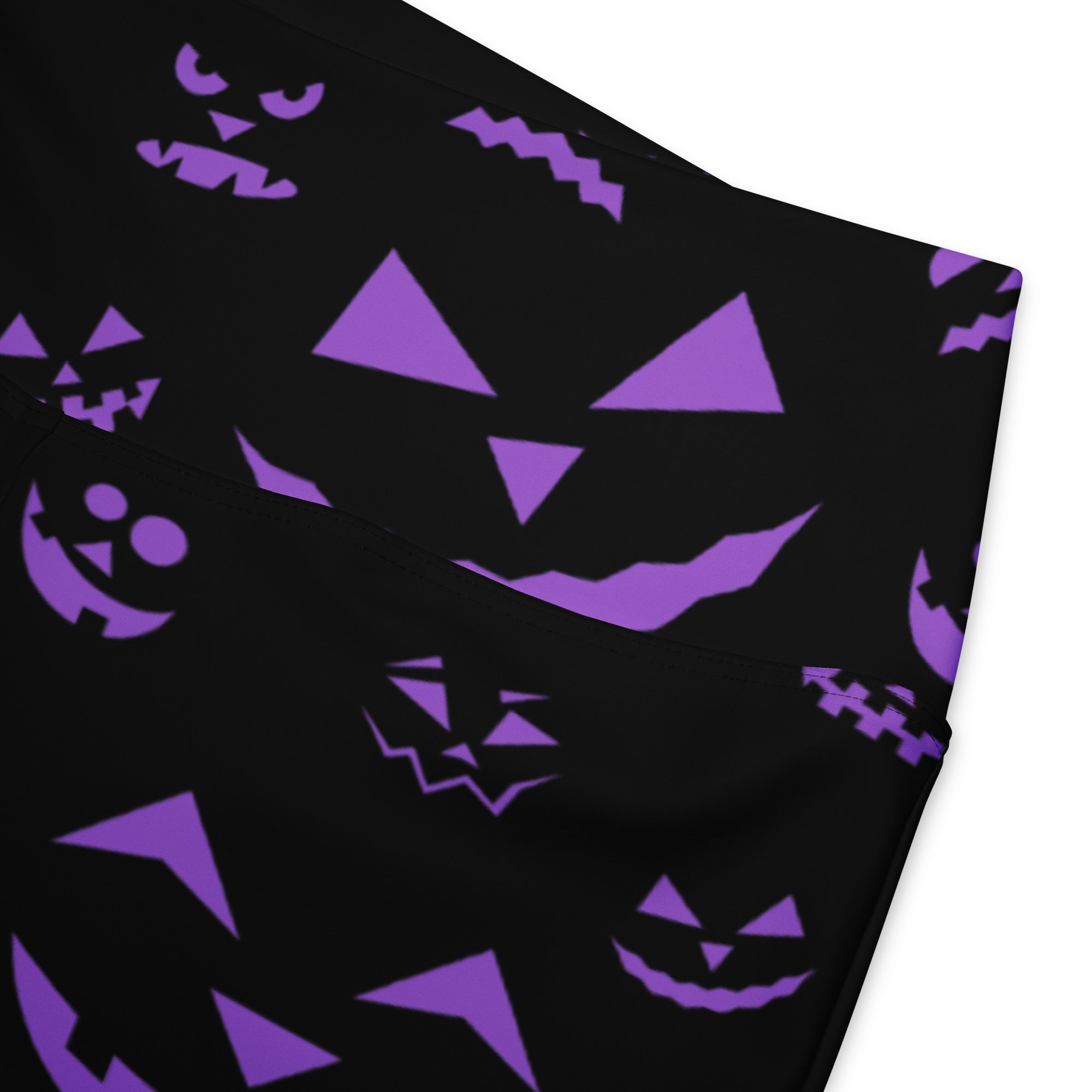 Women’s purple jack-o-lantern high waist flare legging pants in black fabric with repeating purple pumpkin faces pattern