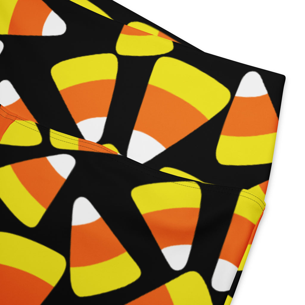 Black women’s high waist flare leggings with a vibrant orange yellow and white candy corn pattern
