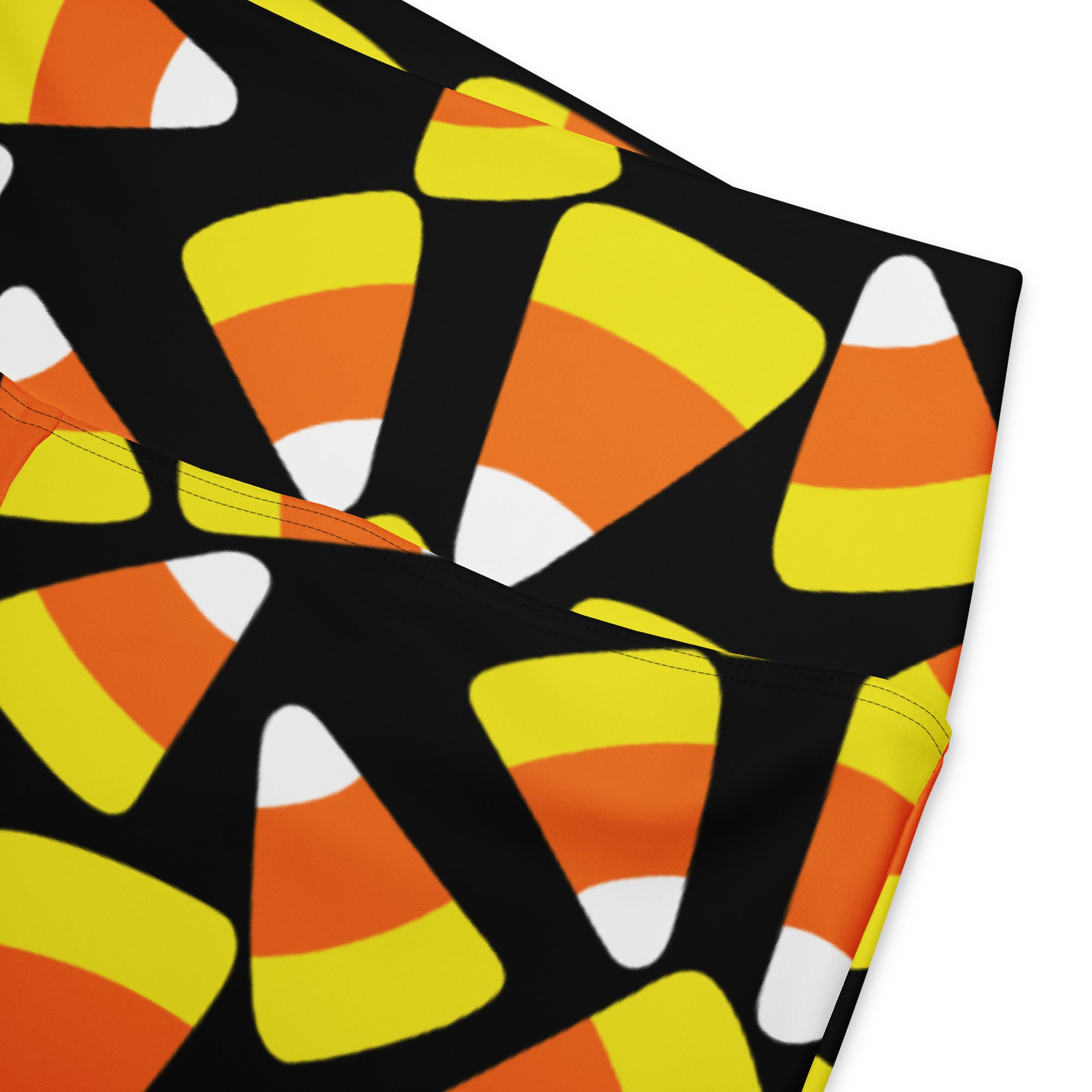 Black women’s high waist flare leggings with a vibrant orange yellow and white candy corn pattern