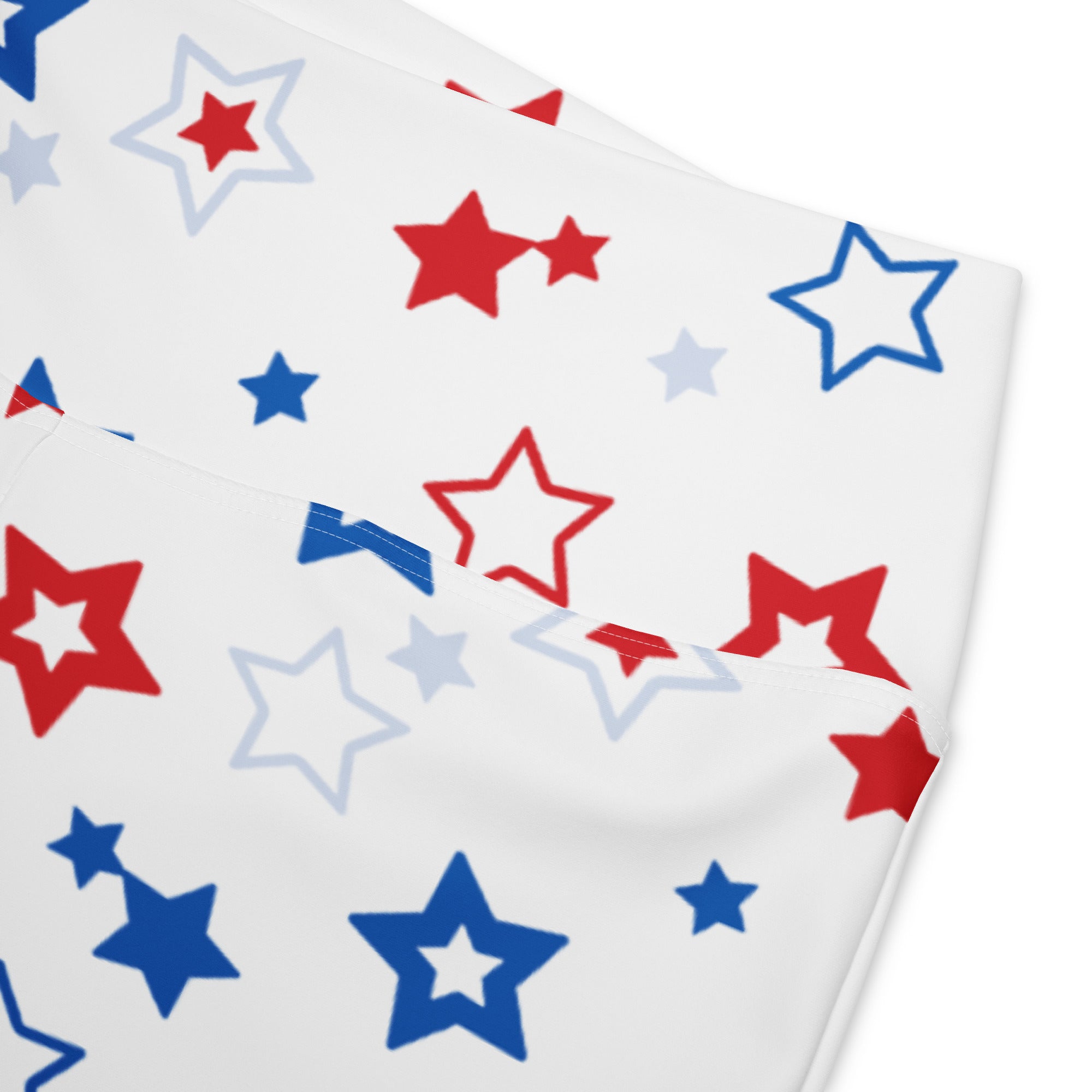 White high waist flare legging pants with playful red blue and light gray star pattern on fabric