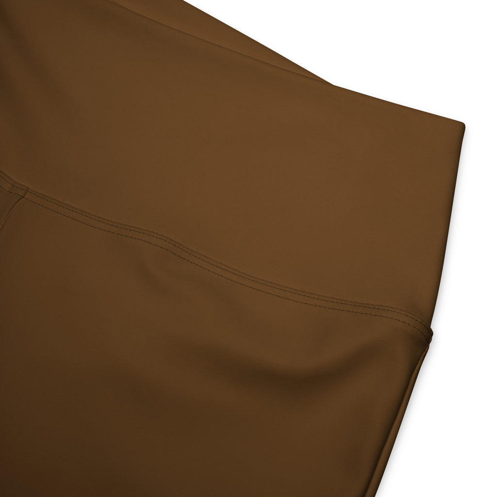 Women’s brown high waist flare legging pants made of smooth fabric with subtle stitching detail visible in the image
