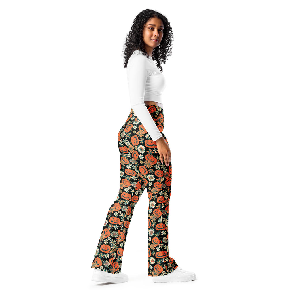 Women’s retro halloween high waist flare legging pants in black with orange jack o lanterns and white daisies pattern