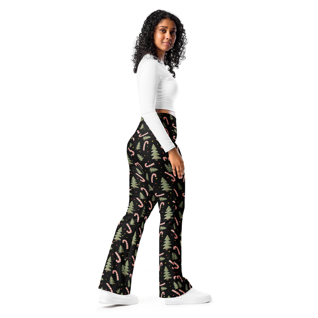 Women’s black Christmas candy cane high waist flare legging pants with pink candy canes and green pine trees pattern