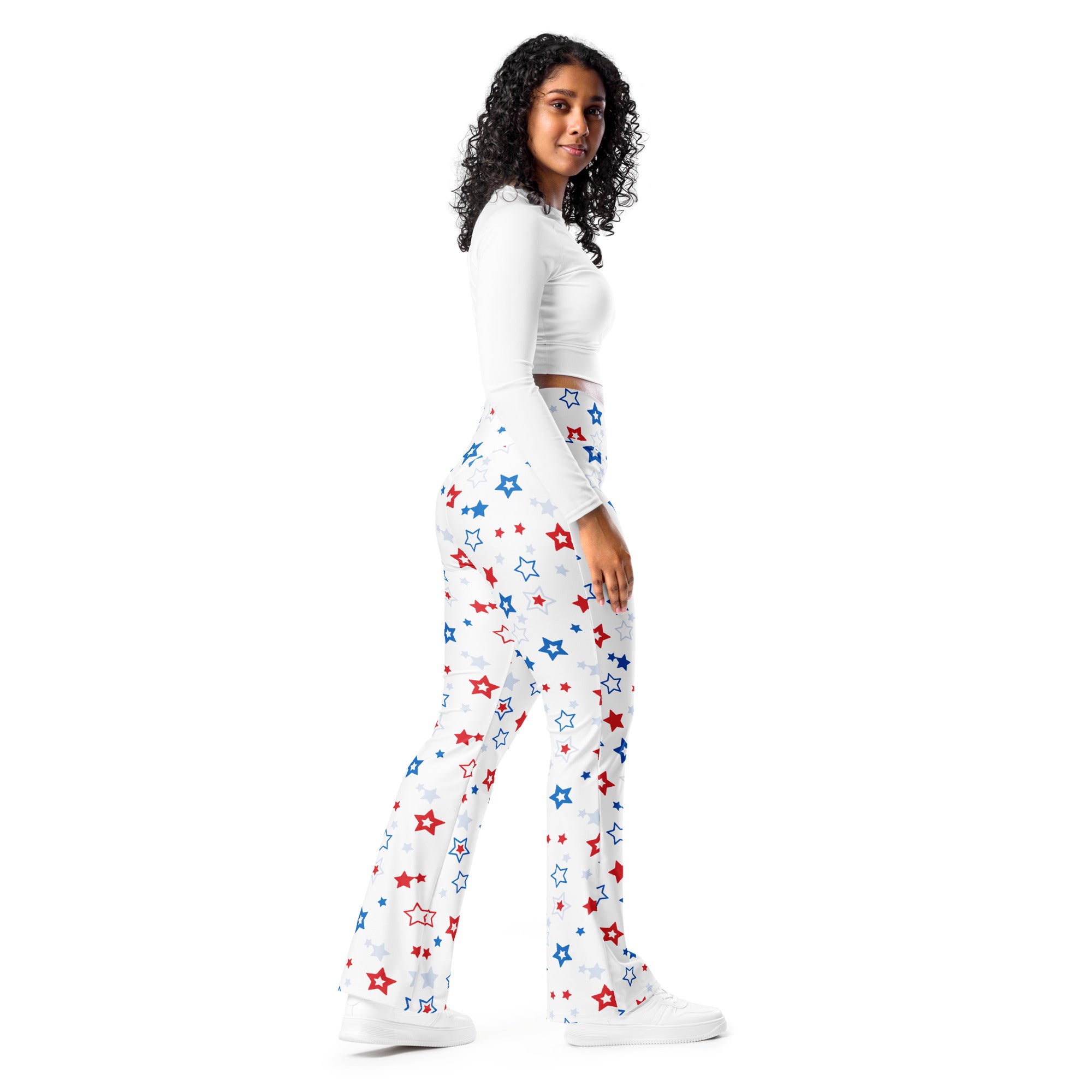White flare legging pants featuring a playful pattern of red blue and silver stars and a high waist design