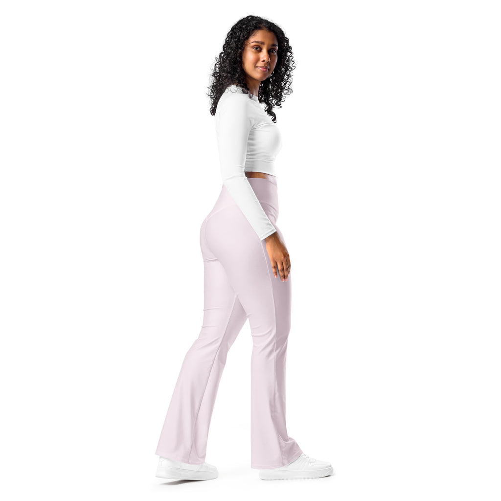A pair of women’s light pink high waist flare leggings made of smooth stretchy fabric shown from the front