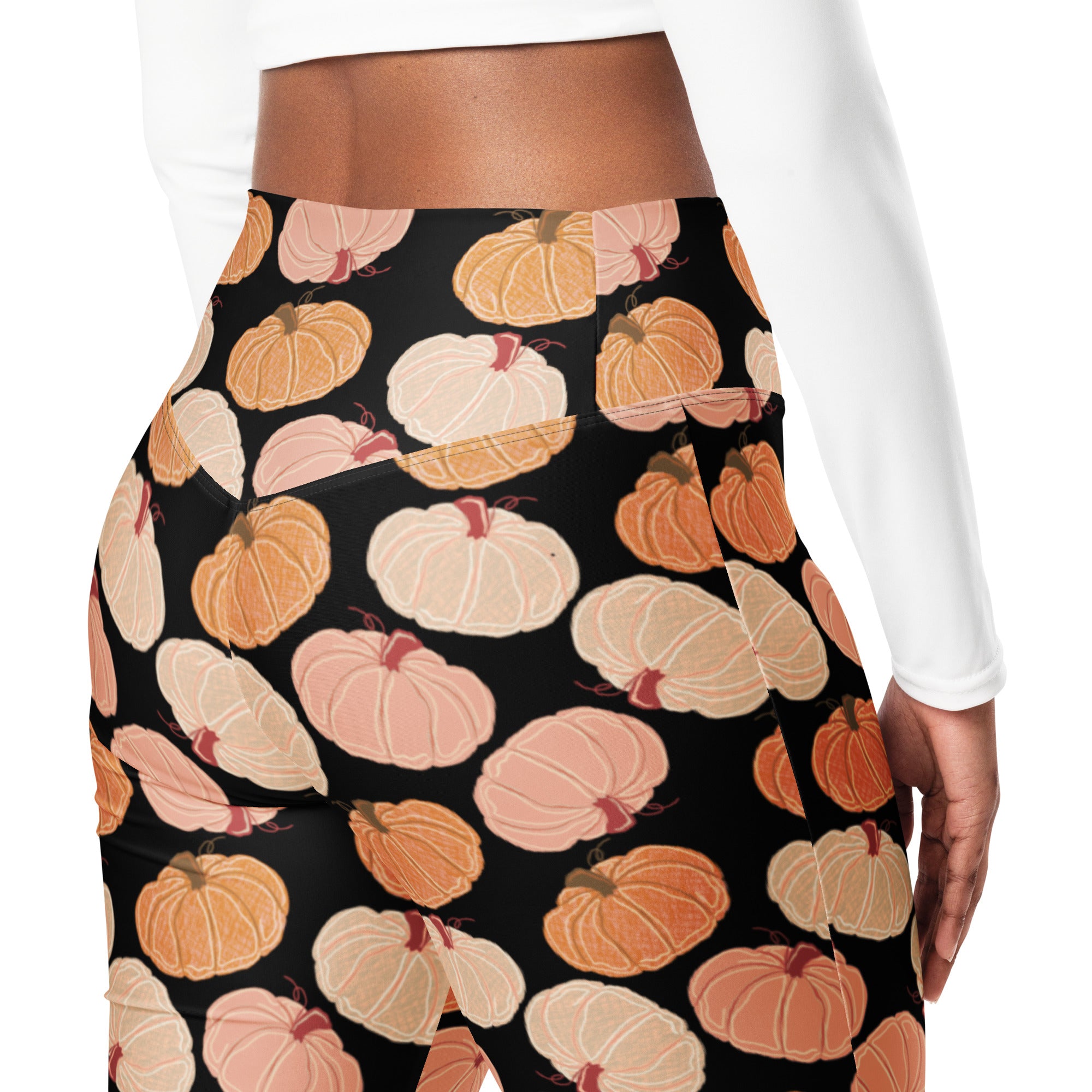 Women’s black high waist flare leggings with playful orange peach and cream illustrated pumpkin pattern
