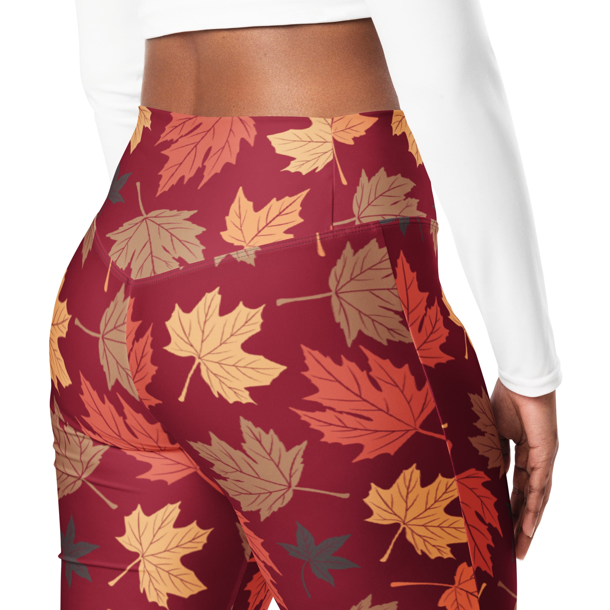 Women’s maroon high waist flare leggings with vibrant orange yellow and brown autumn leaf pattern