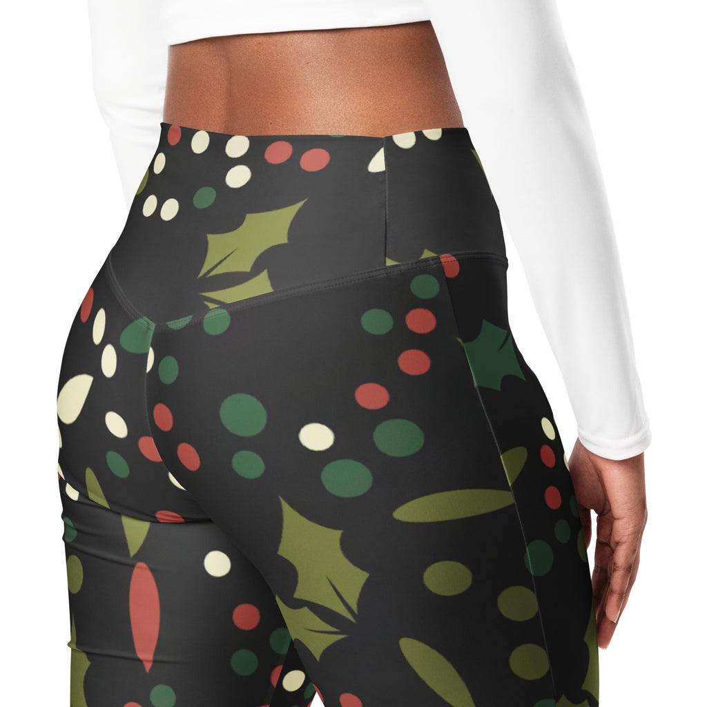 Black high-waisted women’s leggings with festive holly print, red and white polka dots, and olive green accents