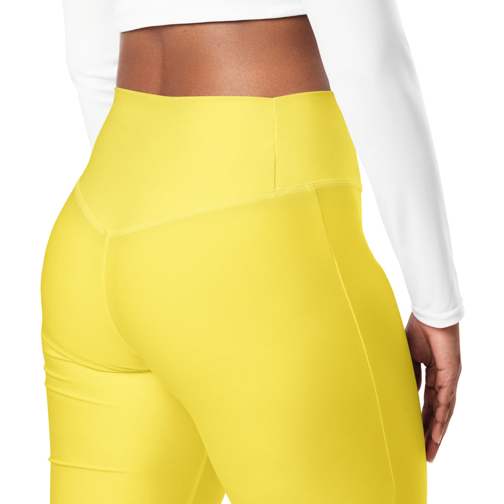 Yellow leggings worn by a person on a white background
