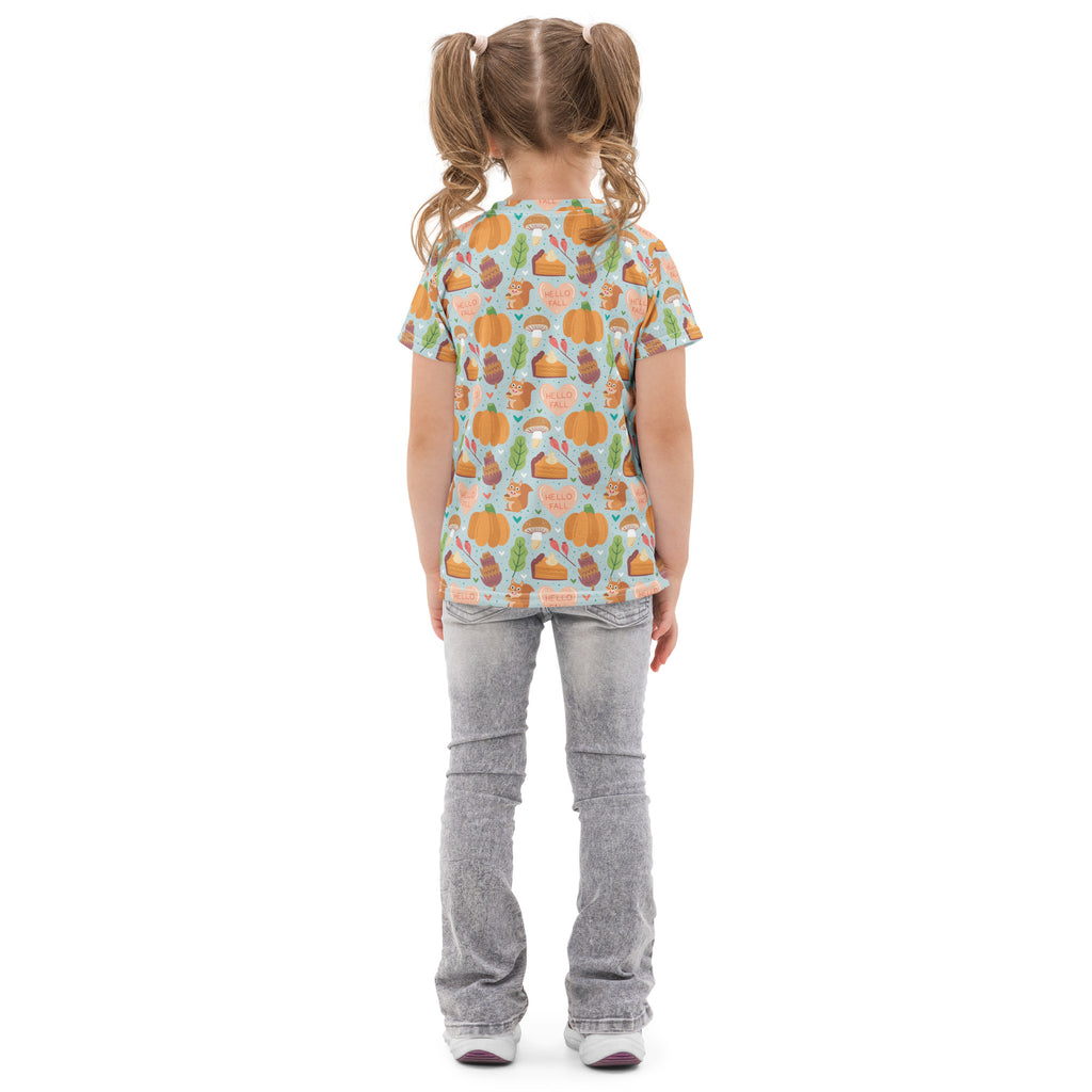 A child wearing a light blue kids hello fall pumpkin cotton t-shirt with playful autumn pumpkins pies and squirrels pattern