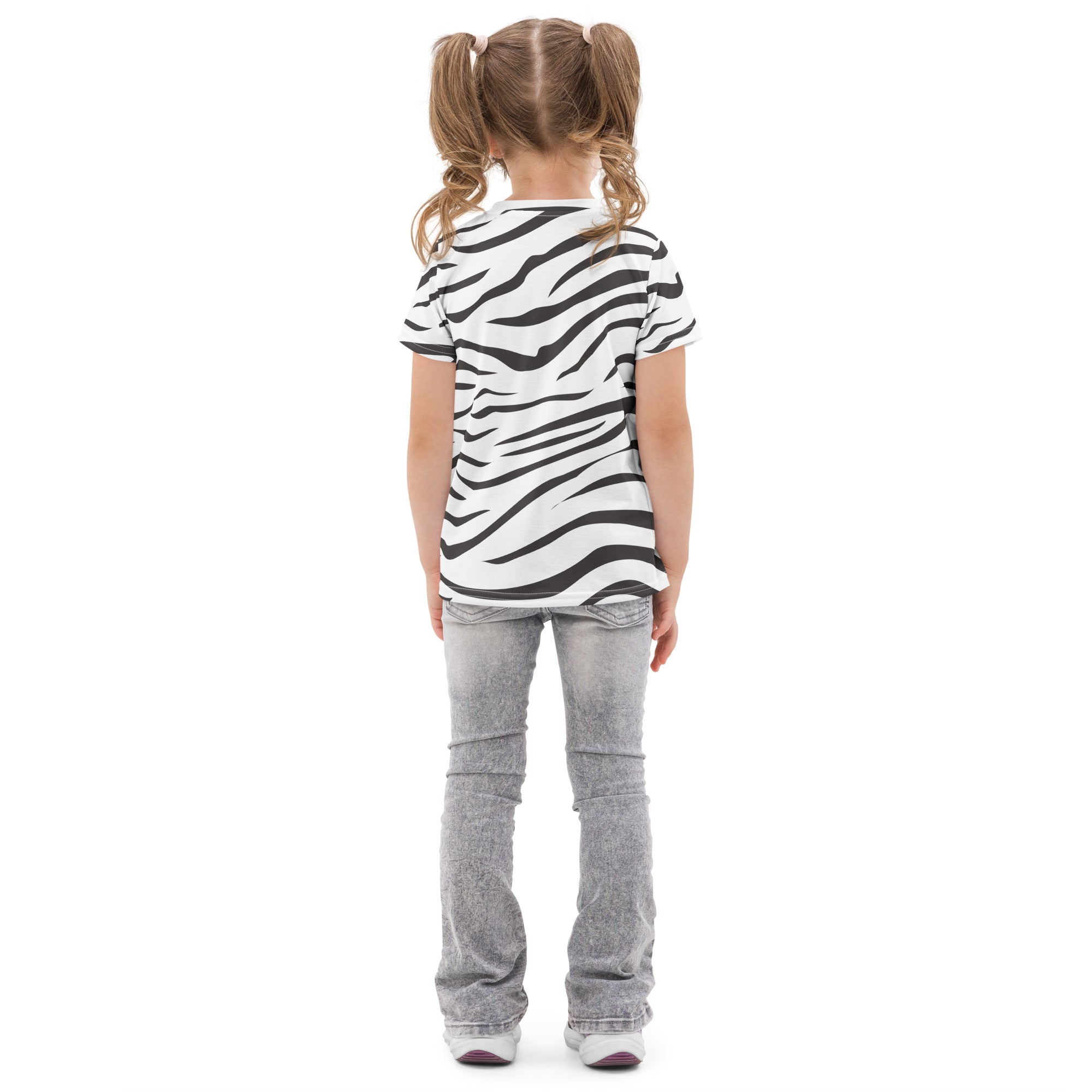 A child wearing a kids zebra print cotton t-shirt in black and white paired with light gray jeans