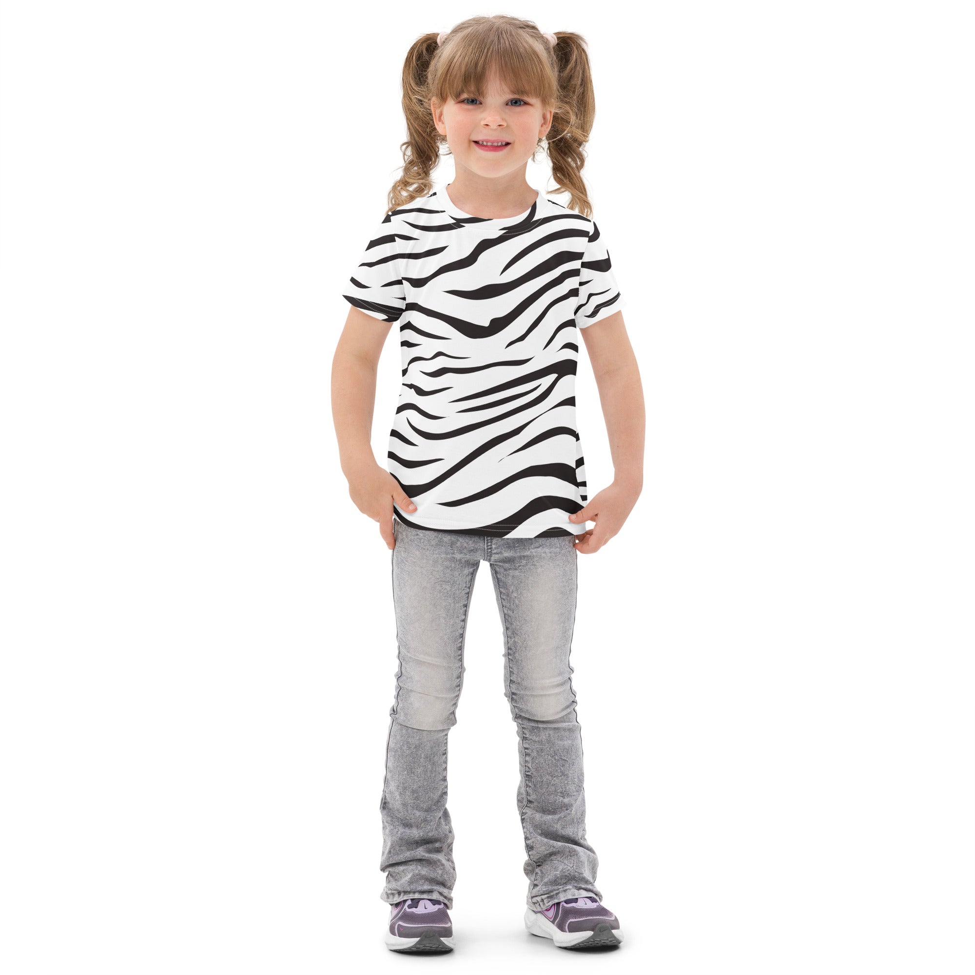 A child wearing a kids zebra print cotton t-shirt in black and white paired with light gray jeans