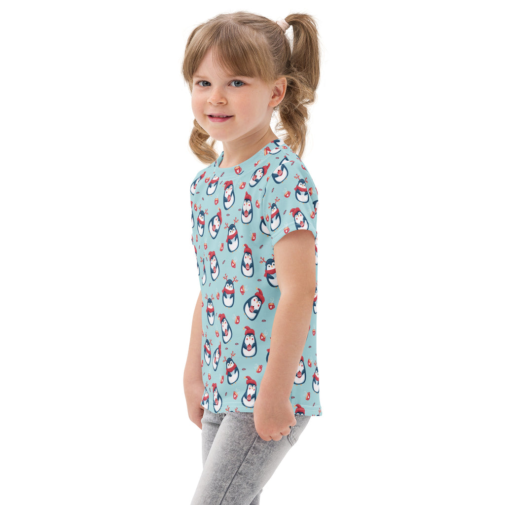 Light blue kids cotton t-shirt with short sleeves featuring playful cartoon penguins wearing red hats and scarves