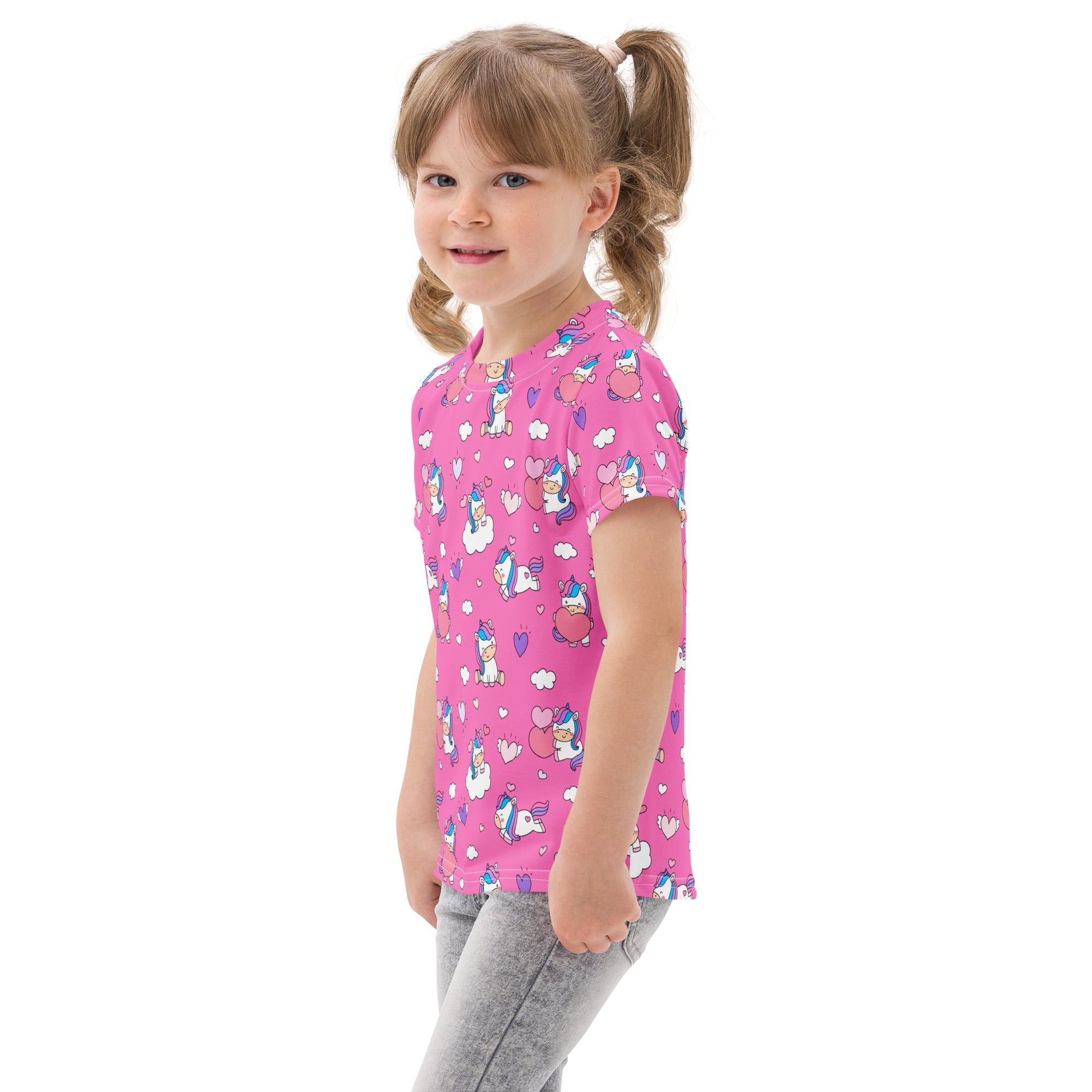 Pink girls cotton t-shirt with playful cartoon unicorns hearts and clouds pattern in blue white and purple