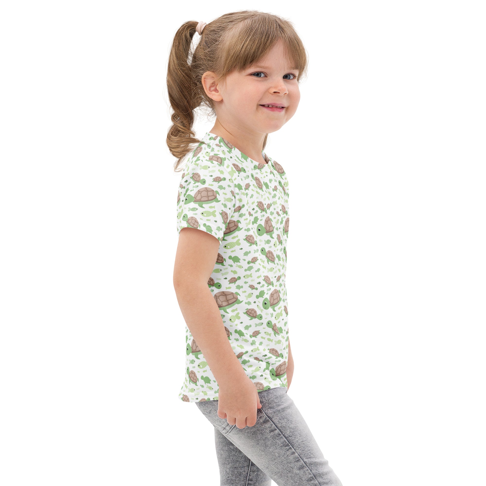 Kids green sea turtles cotton t-shirt with short sleeves and a playful turtle pattern on an off-white background