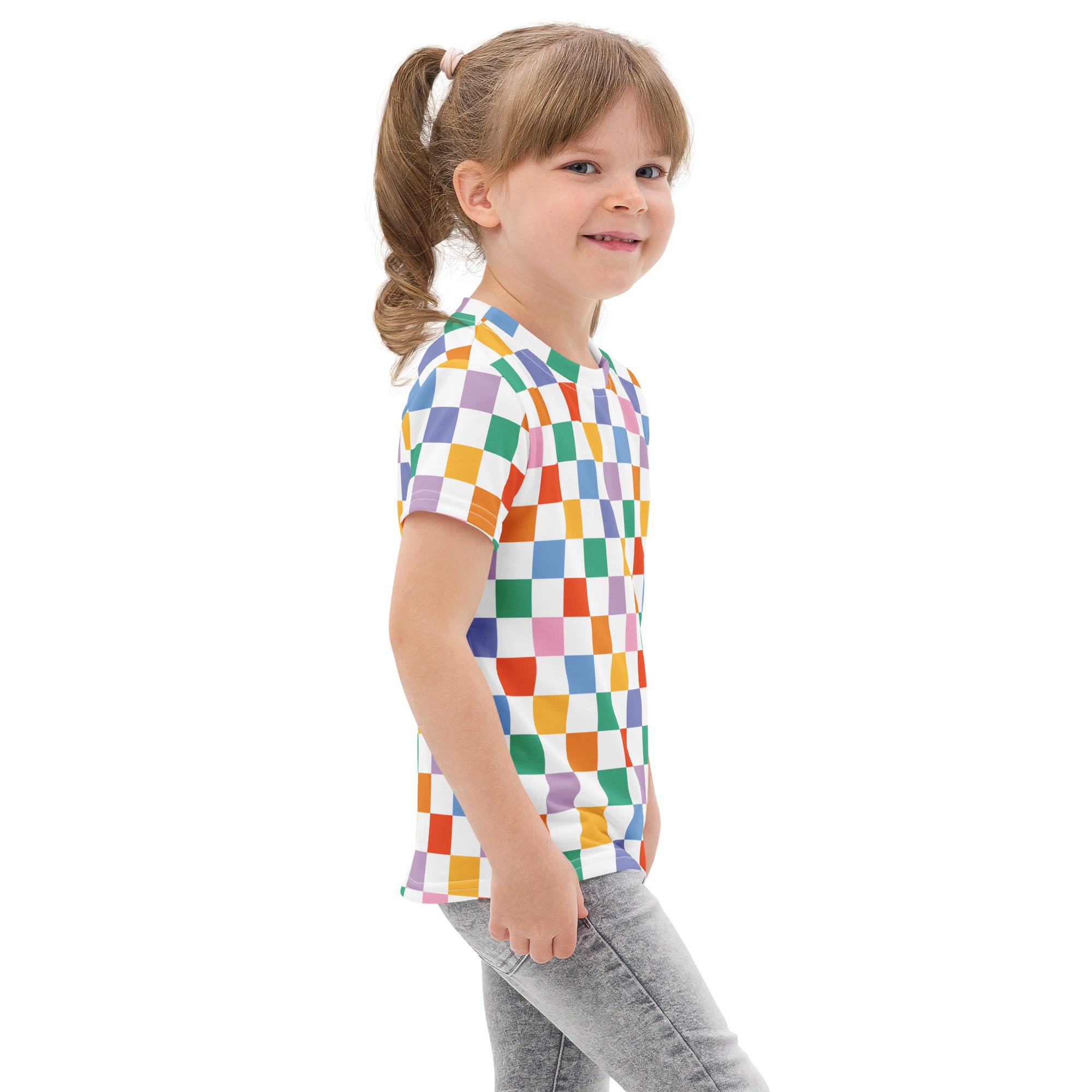 A child wearing a kids rainbow checkerboard cotton t-shirt with colorful checkered short sleeves