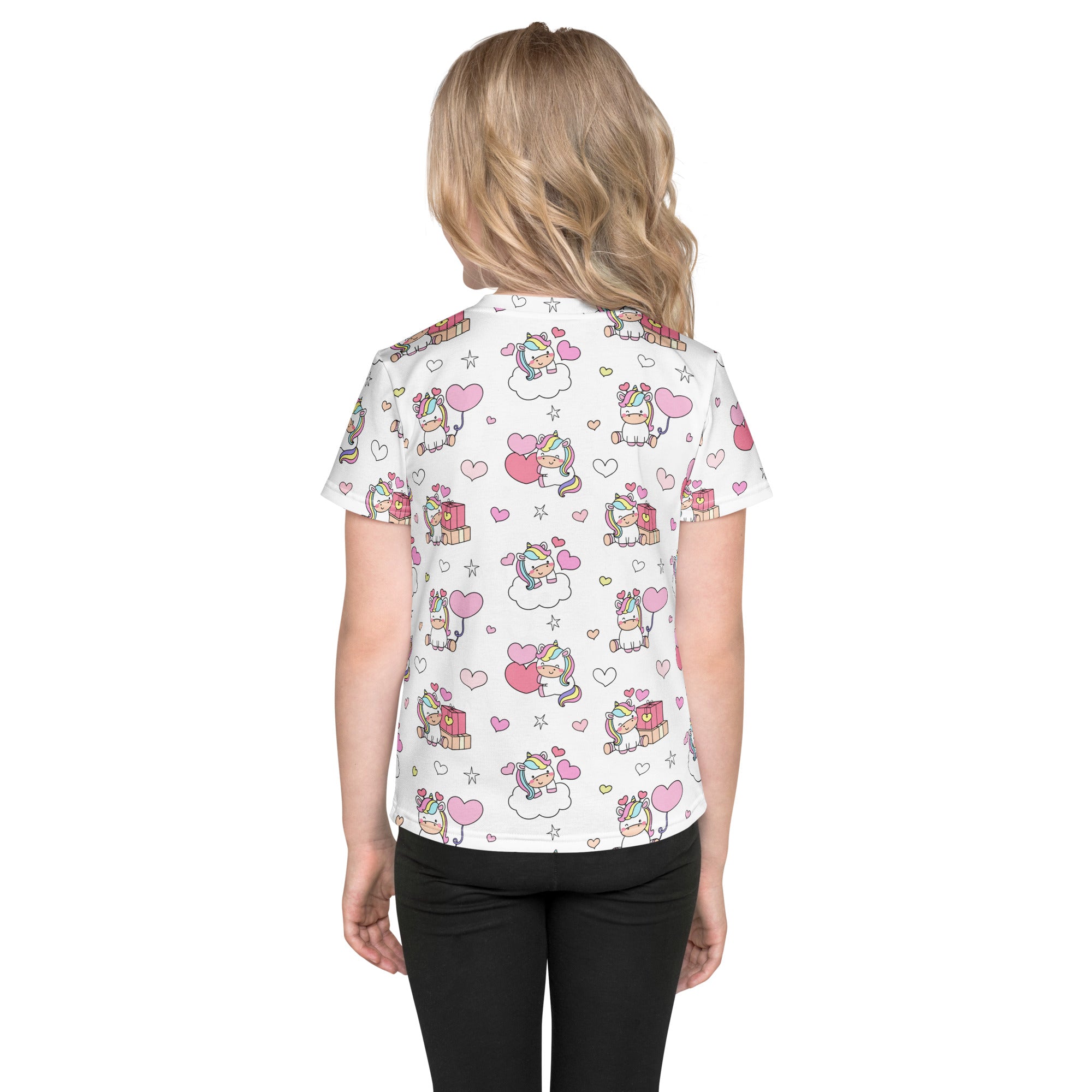 White short-sleeved girls birthday t-shirt with playful unicorn hearts and stars pattern in pink and rainbow colors
