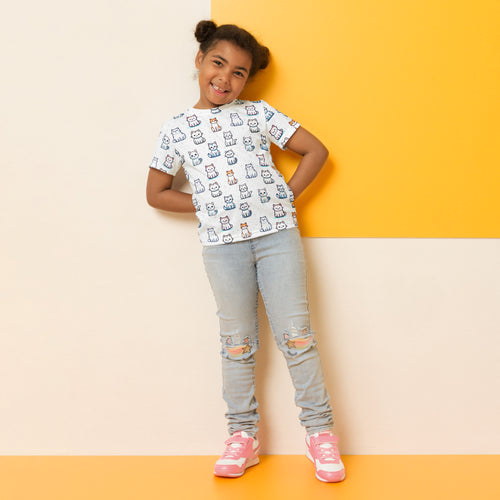 White girls short-sleeved t-shirt with playful cartoon cat pattern in various colors and poses