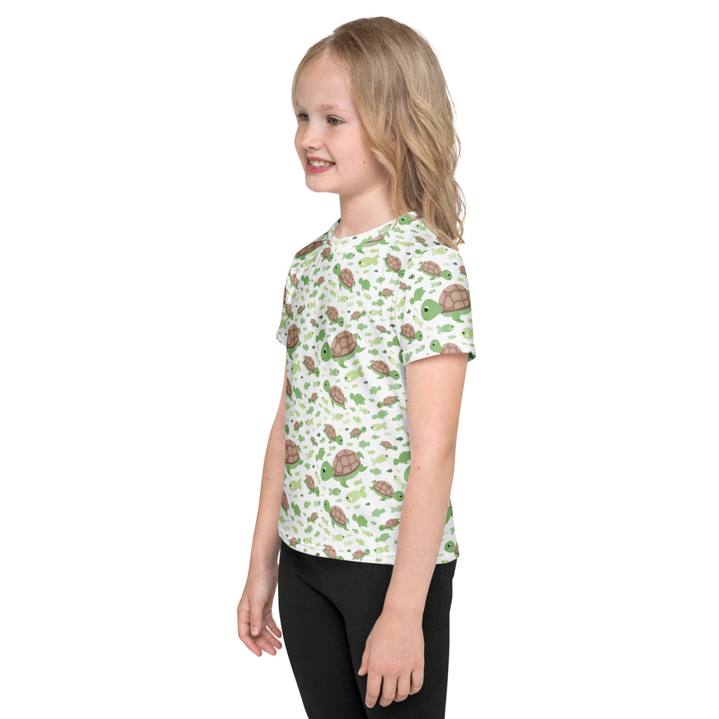 Kids green sea turtles t-shirt with playful green and brown turtle pattern on light off-white short-sleeved cotton tee
