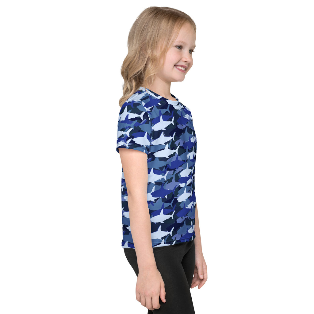 A child wearing a kids blue shark t-shirt with a short-sleeved blue shark camouflage pattern