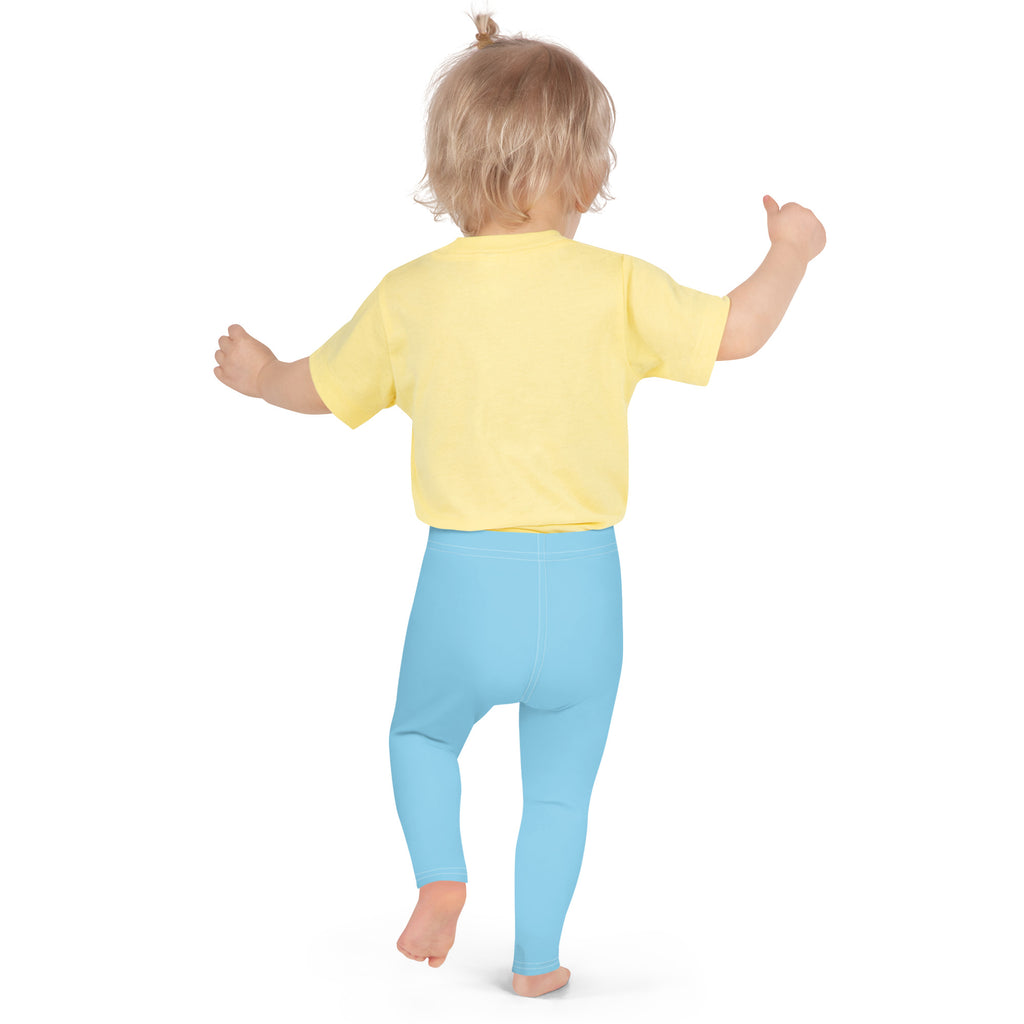 A toddler wearing kids buttery soft sky blue leggings made of soft fabric paired with a bright yellow top