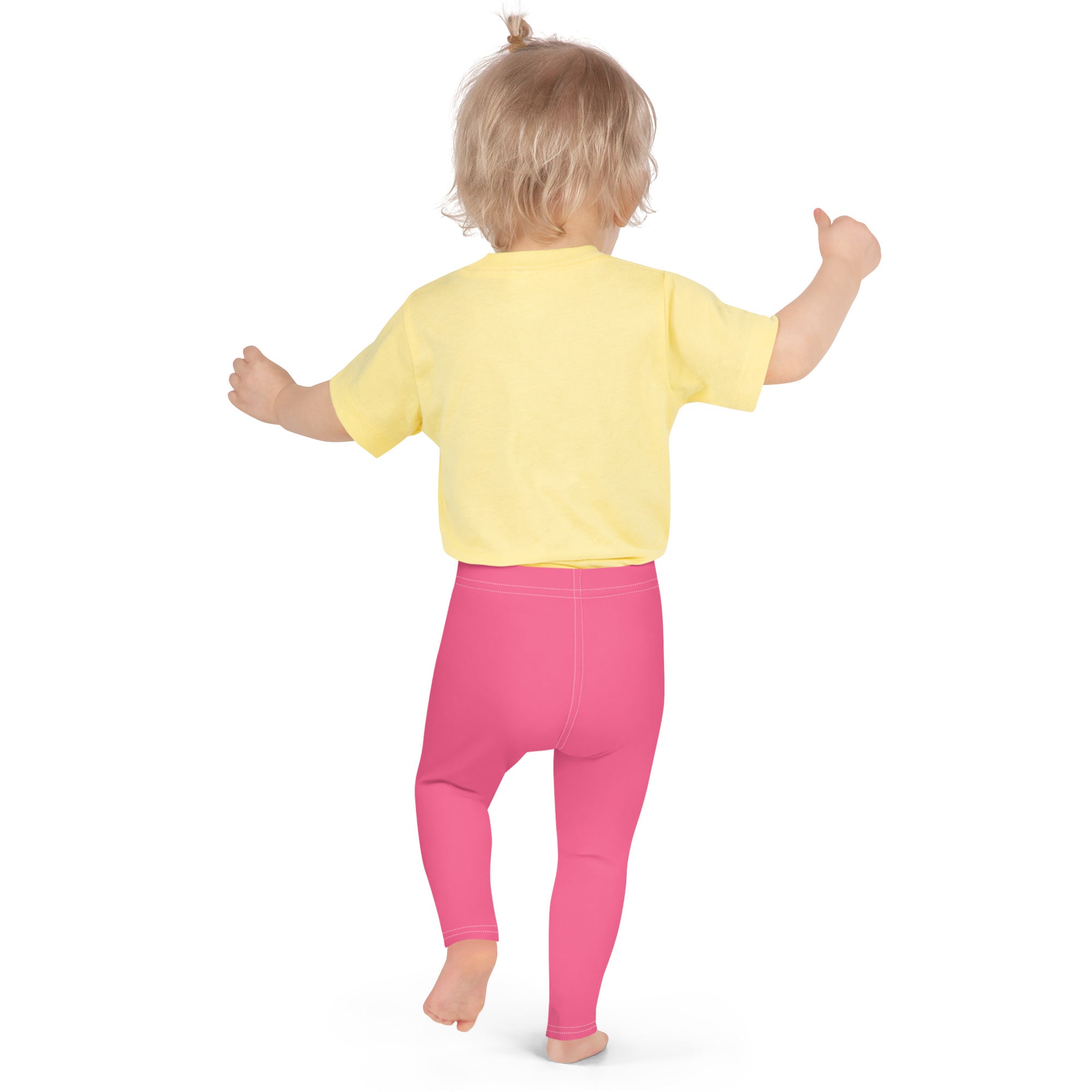 A toddler wearing bright yellow short-sleeved shirt and buttery soft pink girls leggings made of soft fabric
