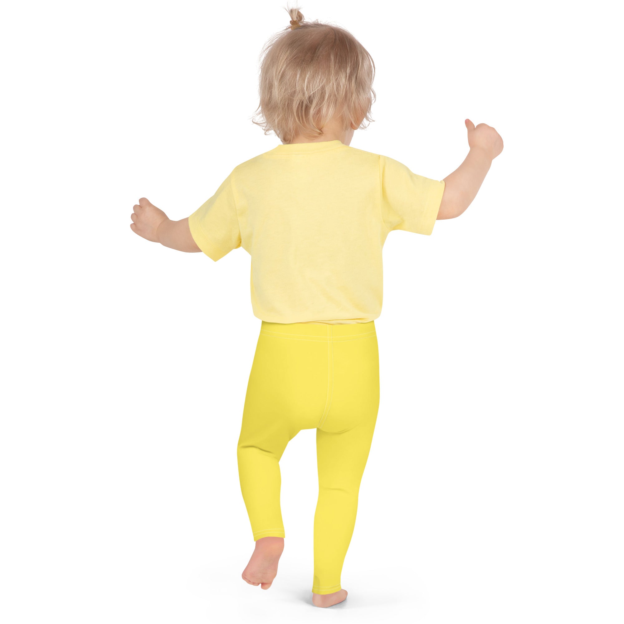 A toddler wearing bright yellow kids buttery soft leggings and matching short-sleeved top for comfortable wear